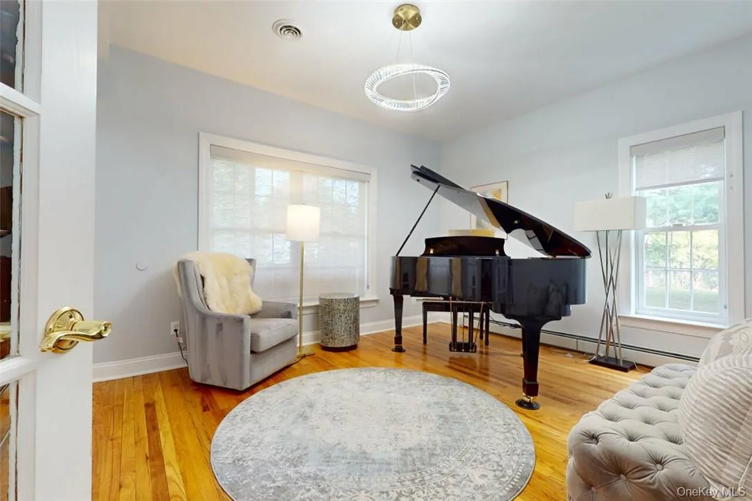 Living Room, now used as a Music Room, light wood flooring with inlay border, beautiful new light fixture Living Room, now used as a Music Room, light wood flooring with inlay border, beautiful new light fixture