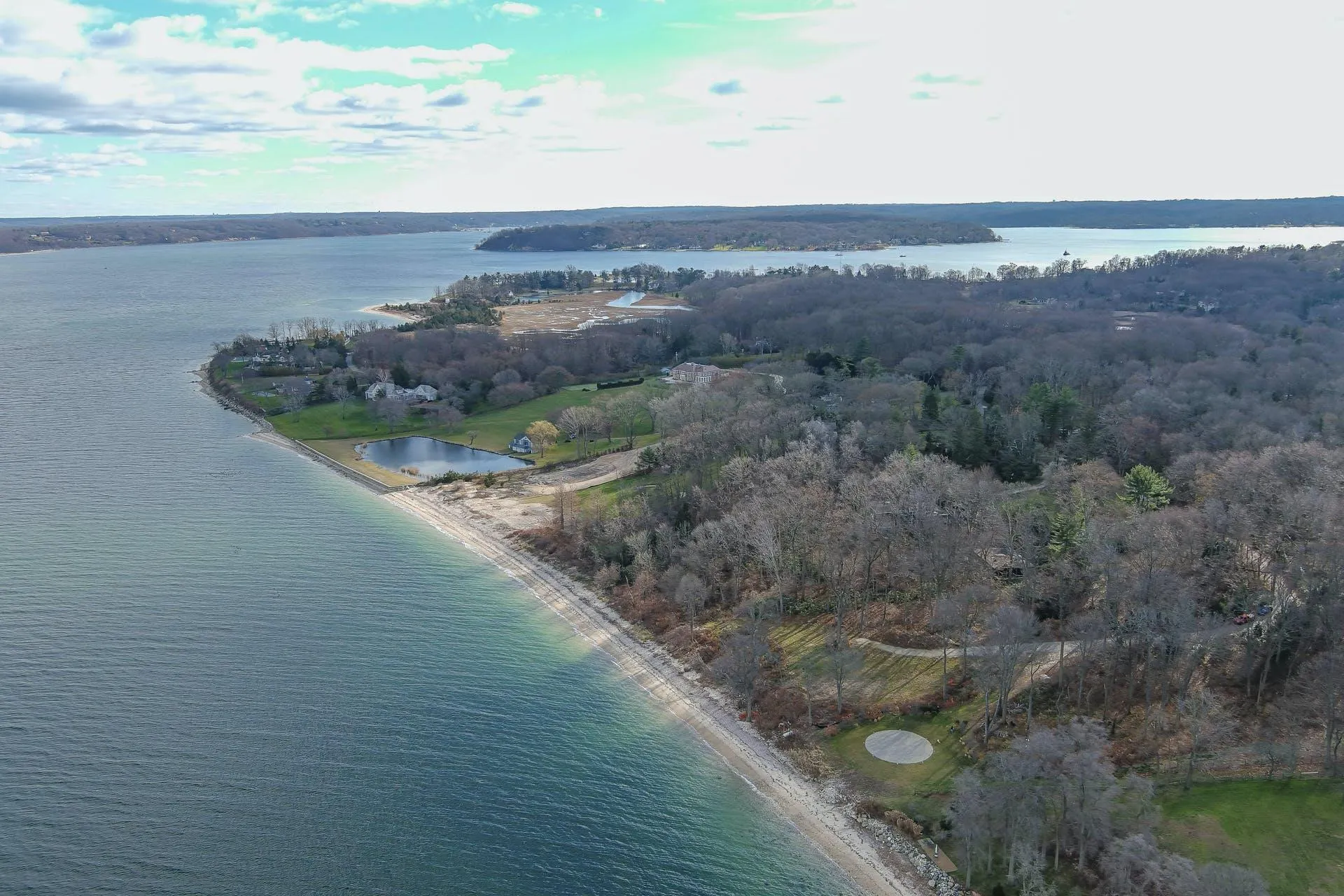 Aerial overview of property's location featuring a nearby body of water and a heavily wooded area Aerial overview of property's location featuring a nearby body of water and a heavily wooded area