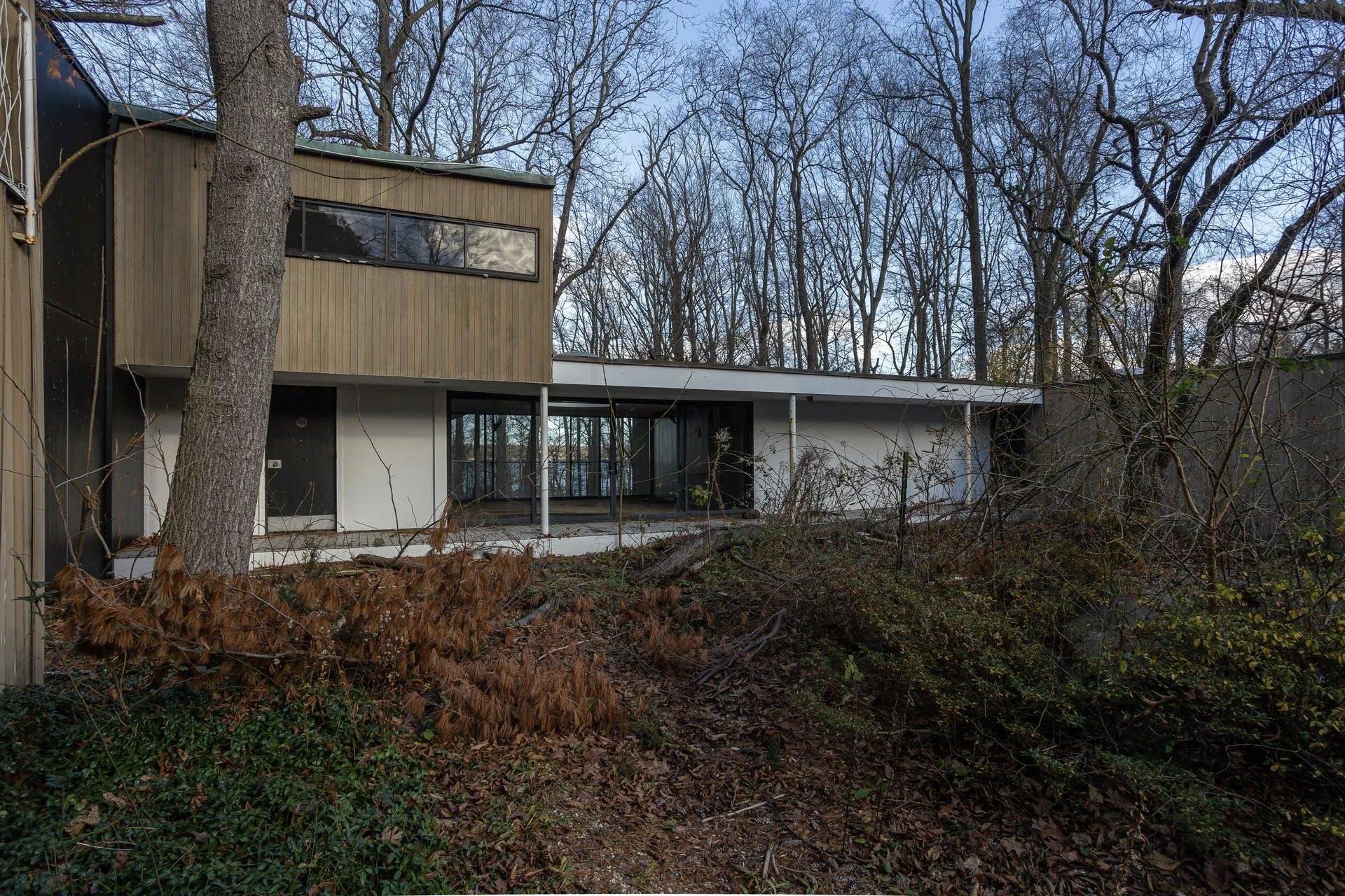 Rear view of property featuring a carport Rear view of property featuring a carport