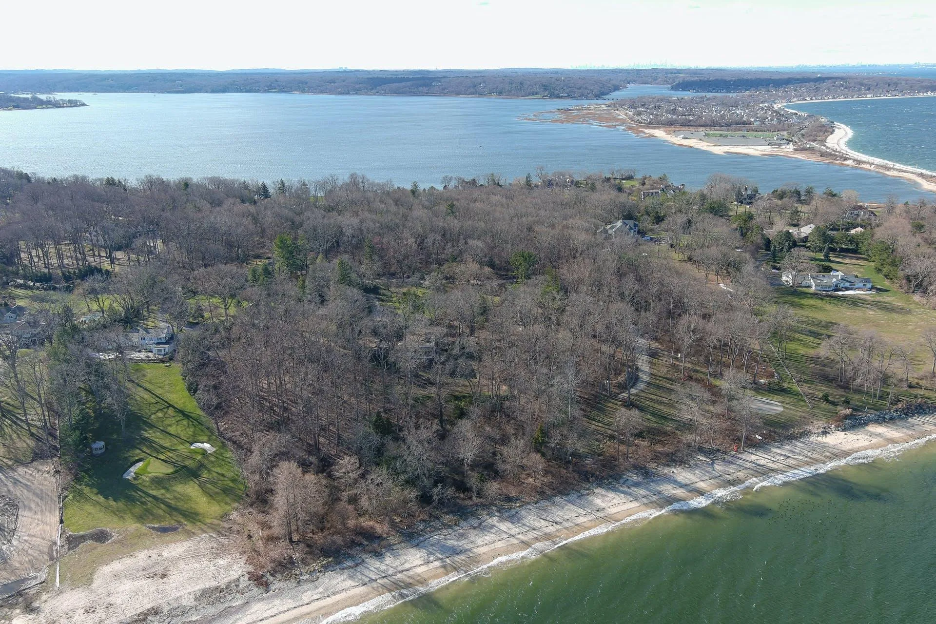 Aerial view of property's location featuring a nearby body of water and a forest Aerial view of property's location featuring a nearby body of water and a forest