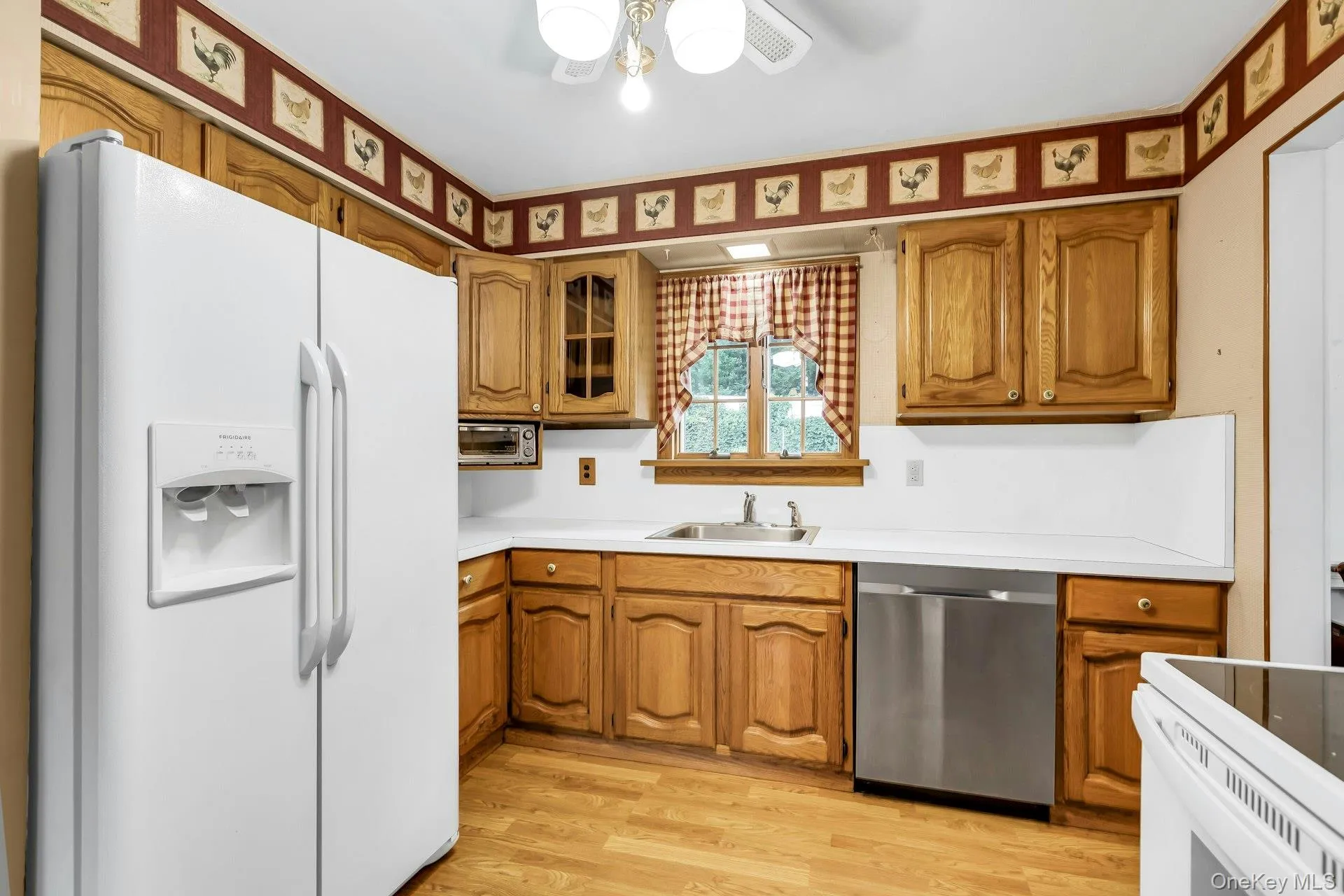 Cabinet Lined Kitchen with Window to Back yard Cabinet Lined Kitchen with Window to Back yard