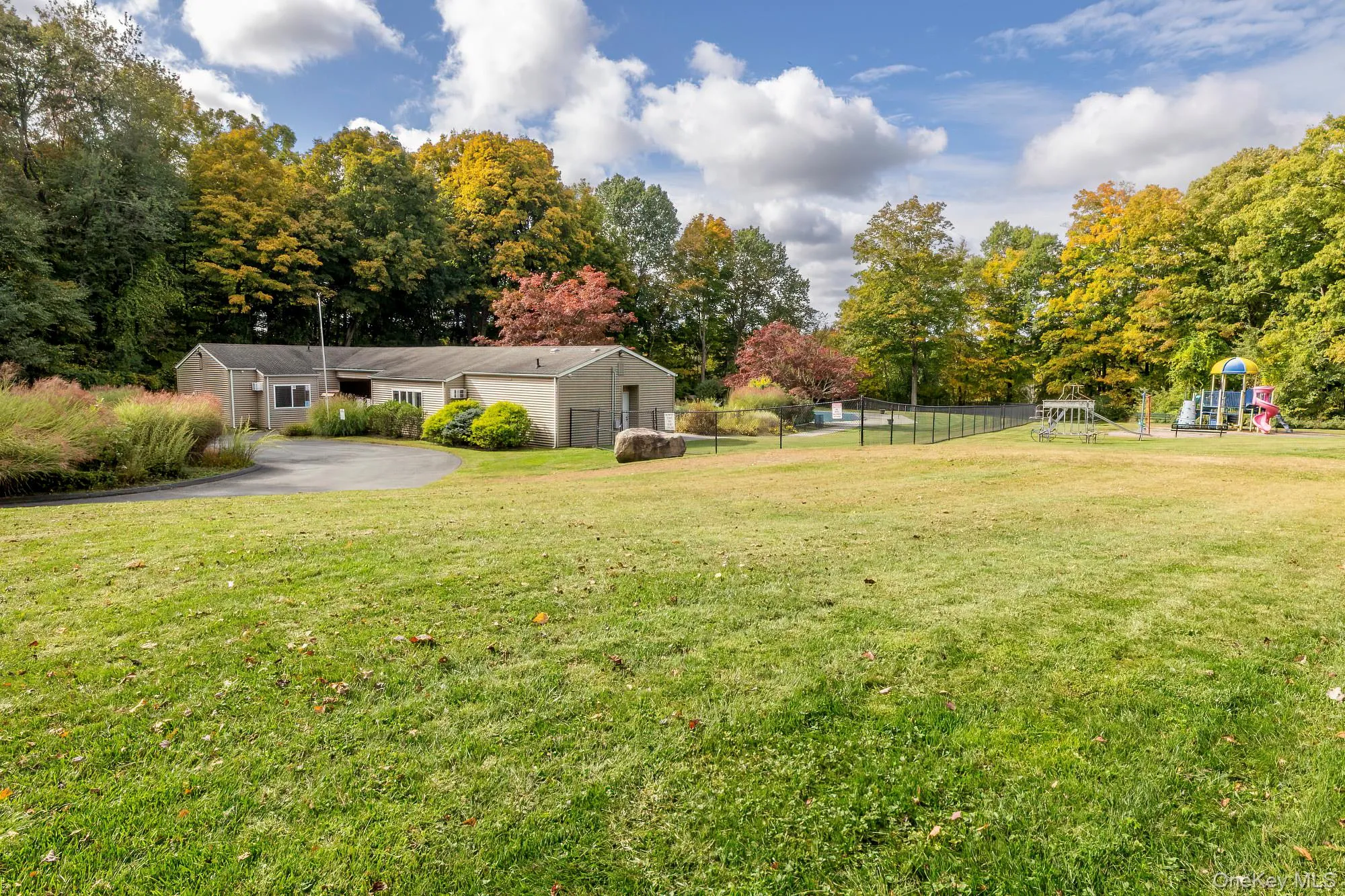 Expansive green lawn with mature trees Expansive green lawn with mature trees