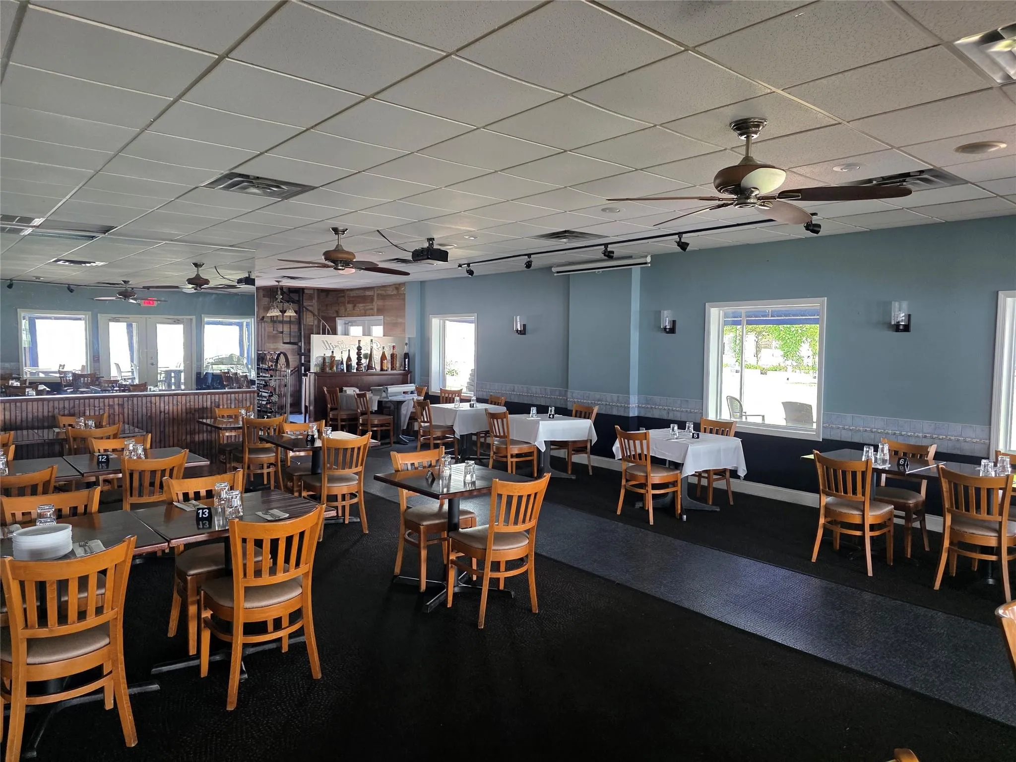 Dining area featuring a ceiling fan and a paneled ceiling Dining area featuring a ceiling fan and a paneled ceiling