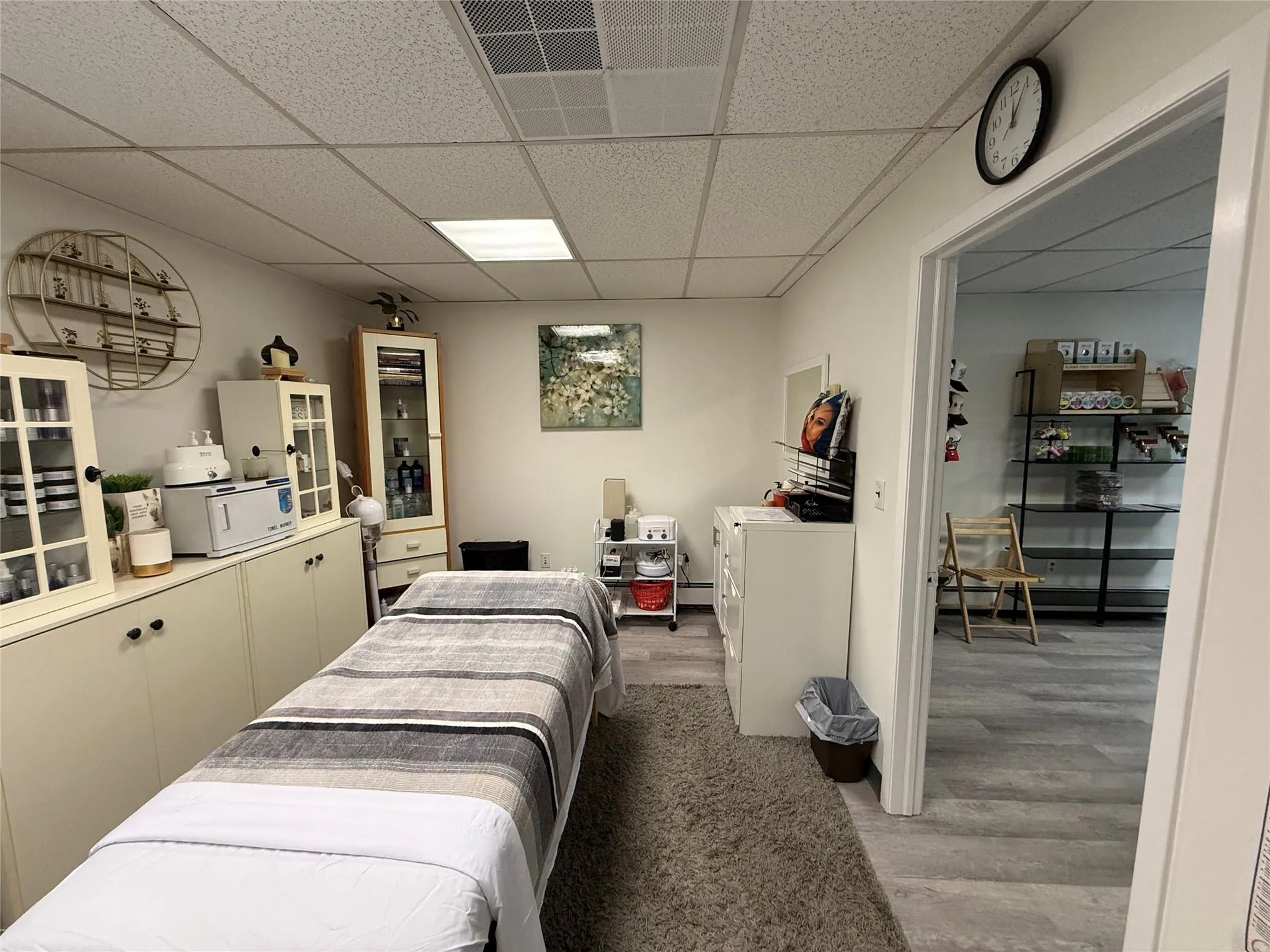 Bedroom with light wood-style floors and a paneled ceiling Bedroom with light wood-style floors and a paneled ceiling