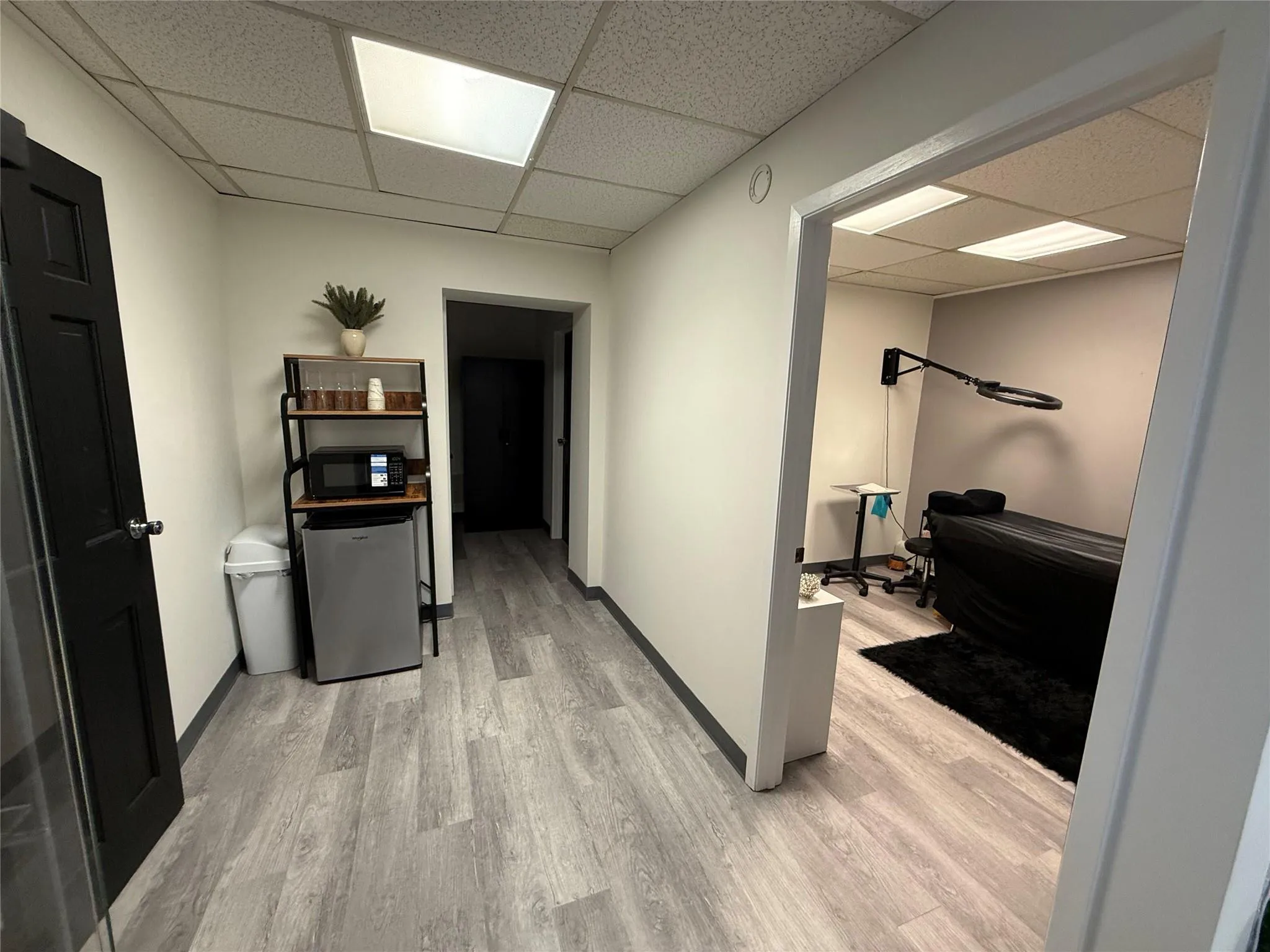 Laundry room with light wood-style flooring and baseboards Laundry room with light wood-style flooring and baseboards