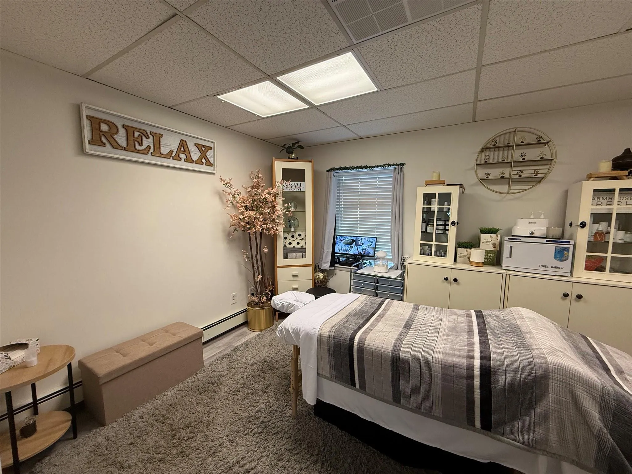 Bedroom with a baseboard radiator, a paneled ceiling, and wood finished floors Bedroom with a baseboard radiator, a paneled ceiling, and wood finished floors