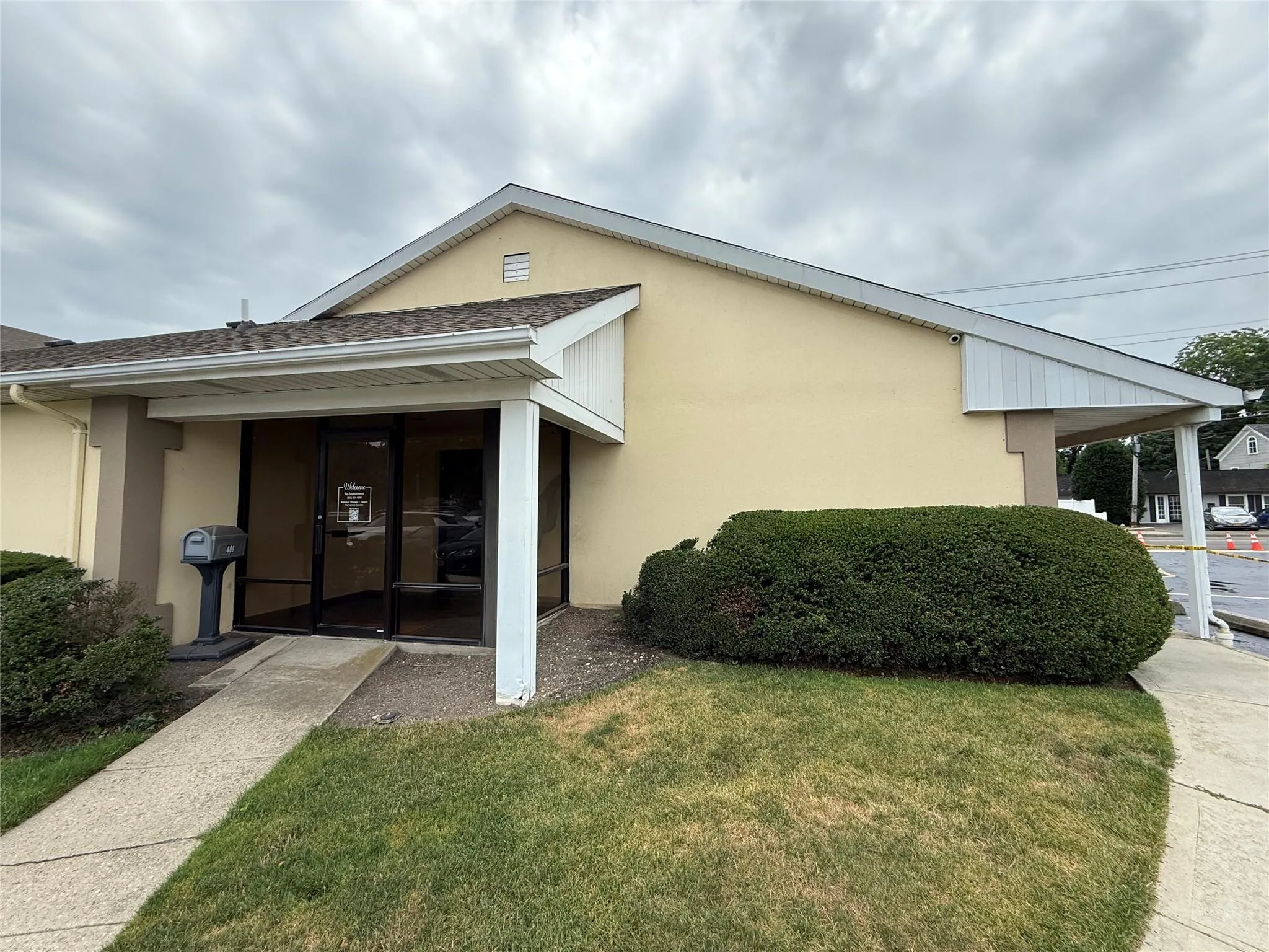 View of front of property featuring stucco siding, a front yard, and a shingled roof View of front of property featuring stucco siding, a front yard, and a shingled roof