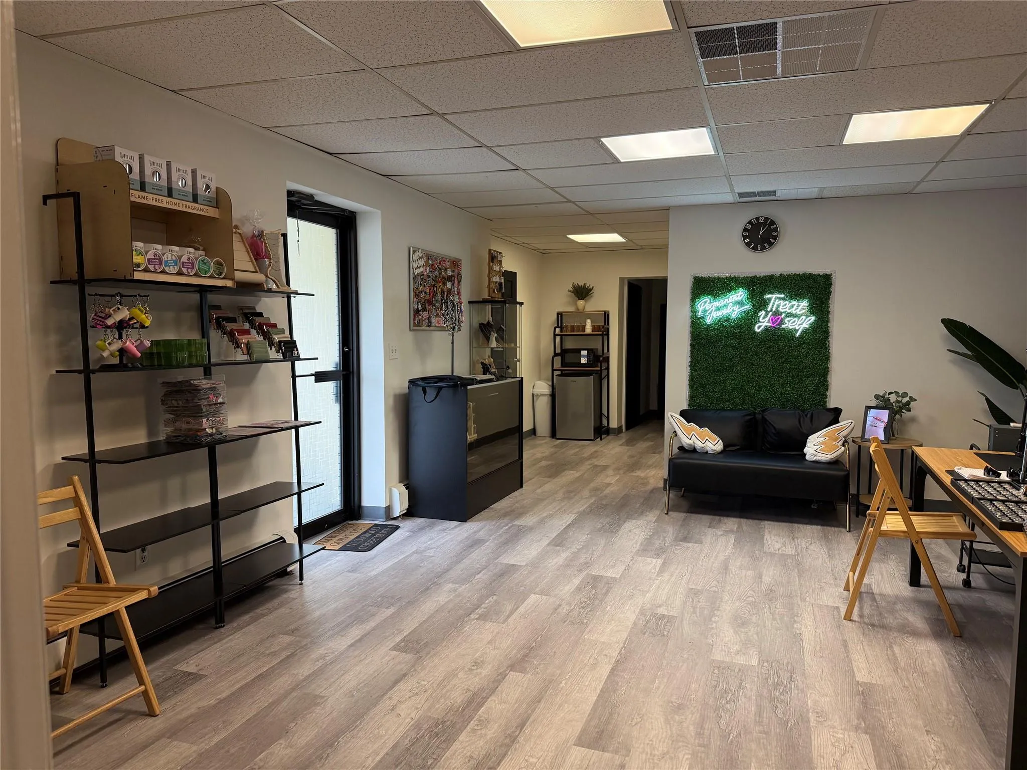 Office area with a paneled ceiling and light wood-style flooring Office area with a paneled ceiling and light wood-style flooring