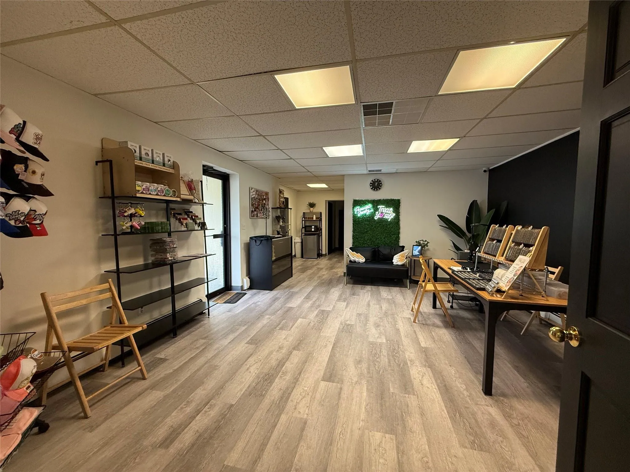 Living area featuring a paneled ceiling and light wood-style floors Living area featuring a paneled ceiling and light wood-style floors
