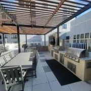 View of patio / terrace with exterior kitchen and outdoor dining space View of patio / terrace with exterior kitchen and outdoor dining space