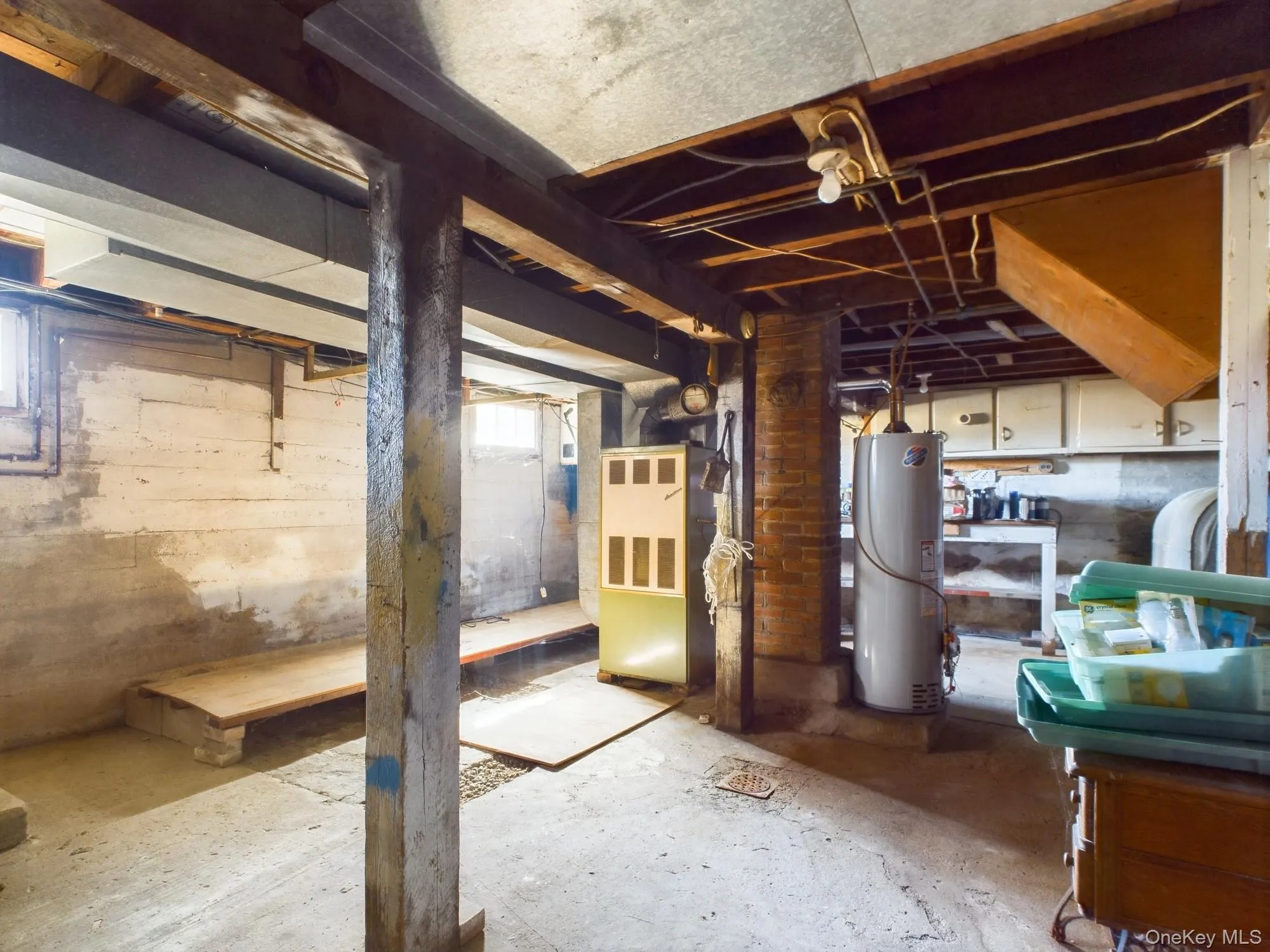 Below grade area featuring water heater and heating unit Below grade area featuring water heater and heating unit