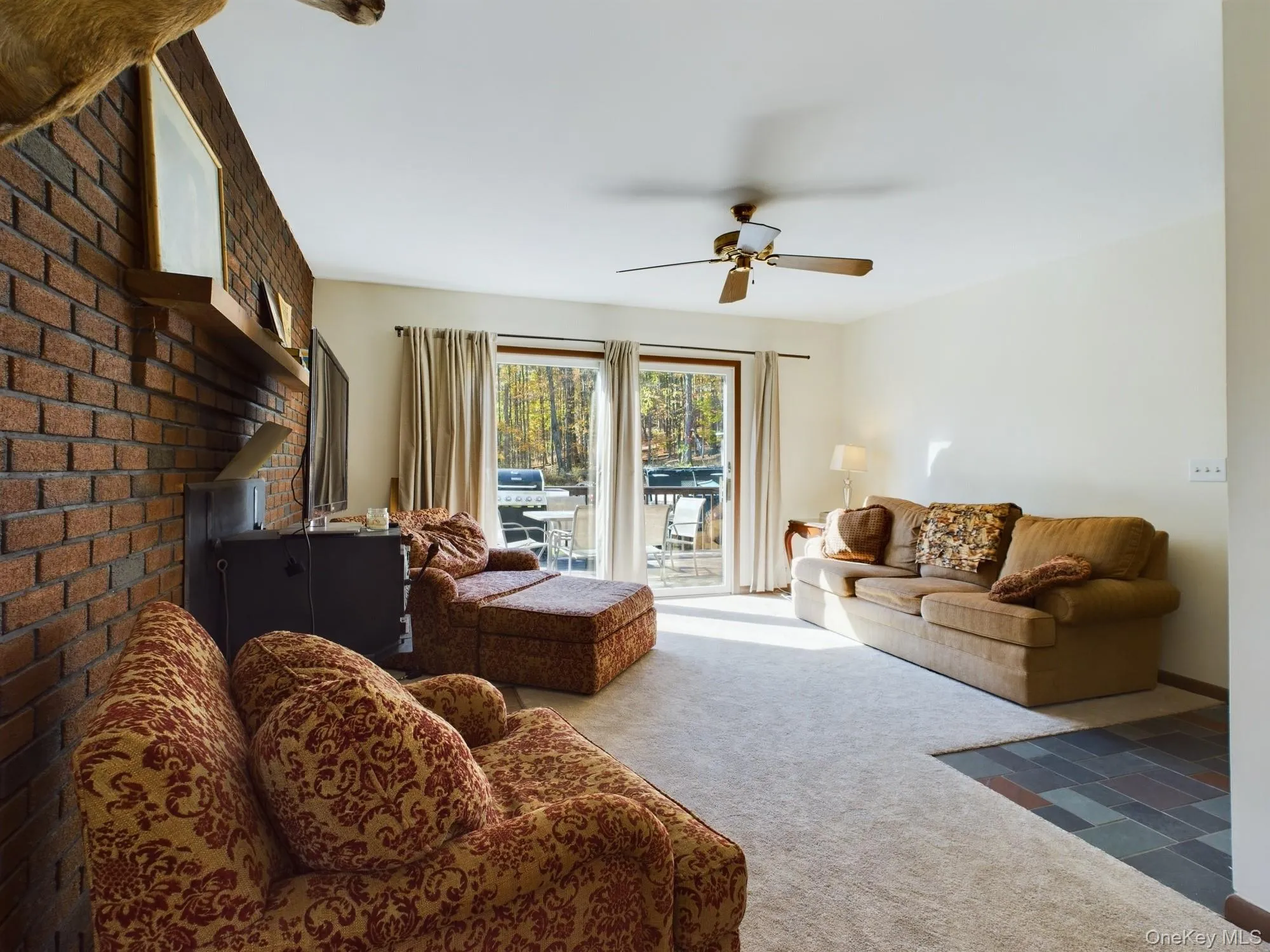 Carpeted living area with ceiling fan Carpeted living area with ceiling fan