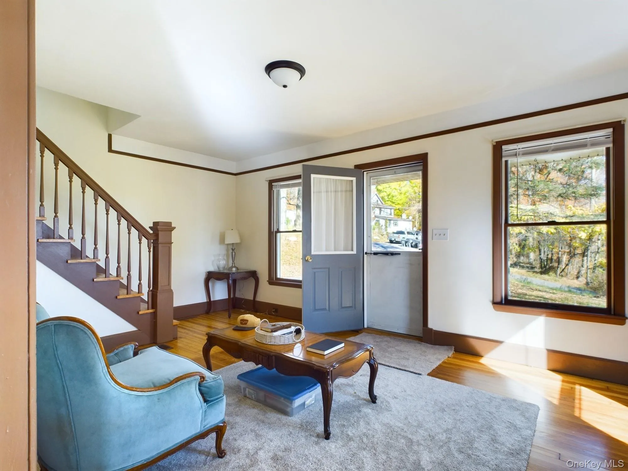 Living room with wood finished floors and stairs Living room with wood finished floors and stairs