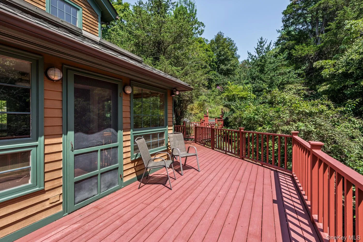 Wooden deck that is outside of the kitchen Wooden deck that is outside of the kitchen