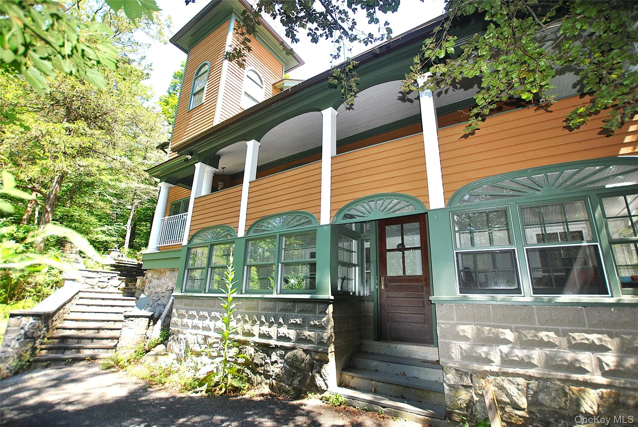Front of house with sone seps leading to huge open covered porch and flagstone patio Front of house with sone seps leading to huge open covered porch and flagstone patio