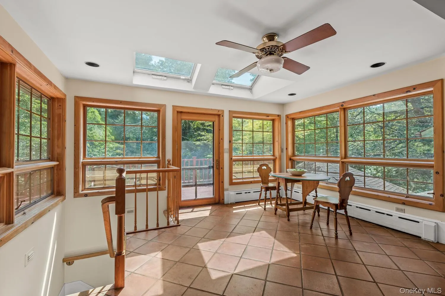 sunlight filled kitchen eating area, door to the deck and stairs to lower level sunlight filled kitchen eating area, door to the deck and stairs to lower level