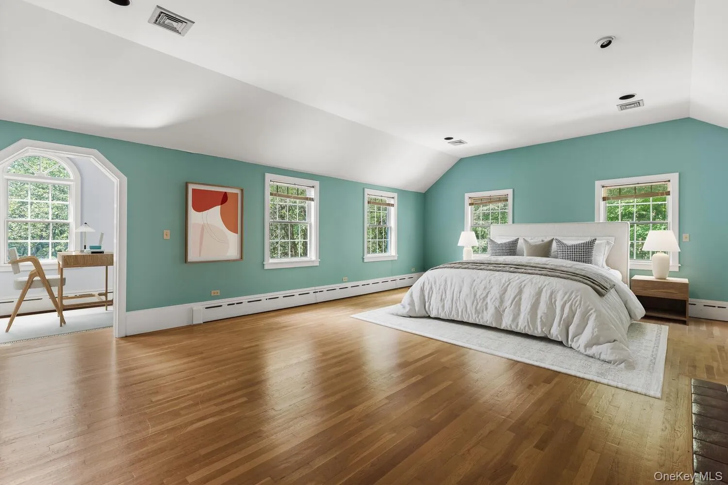 Virtually staged bedroom with vaulted ceiling, wood floors, and cast iron baseboard heating Virtually staged bedroom with vaulted ceiling, wood floors, and cast iron baseboard heating