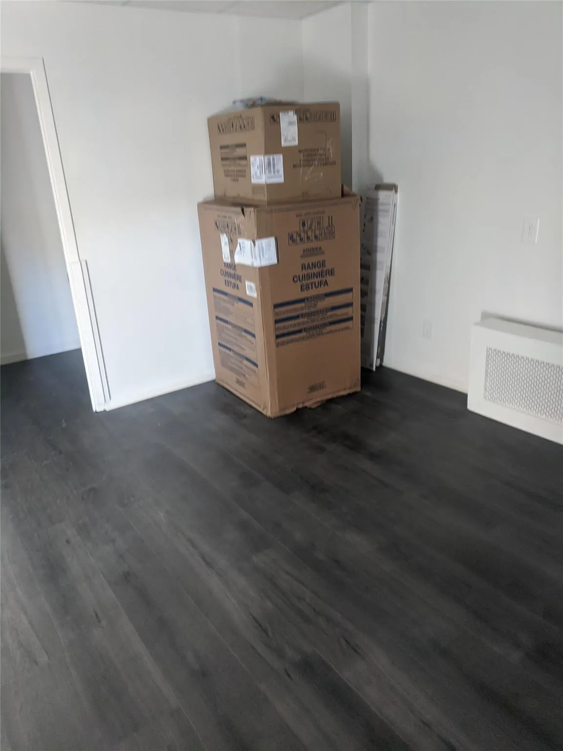 Detailed view of wood finished floors and radiator heating unit Detailed view of wood finished floors and radiator heating unit