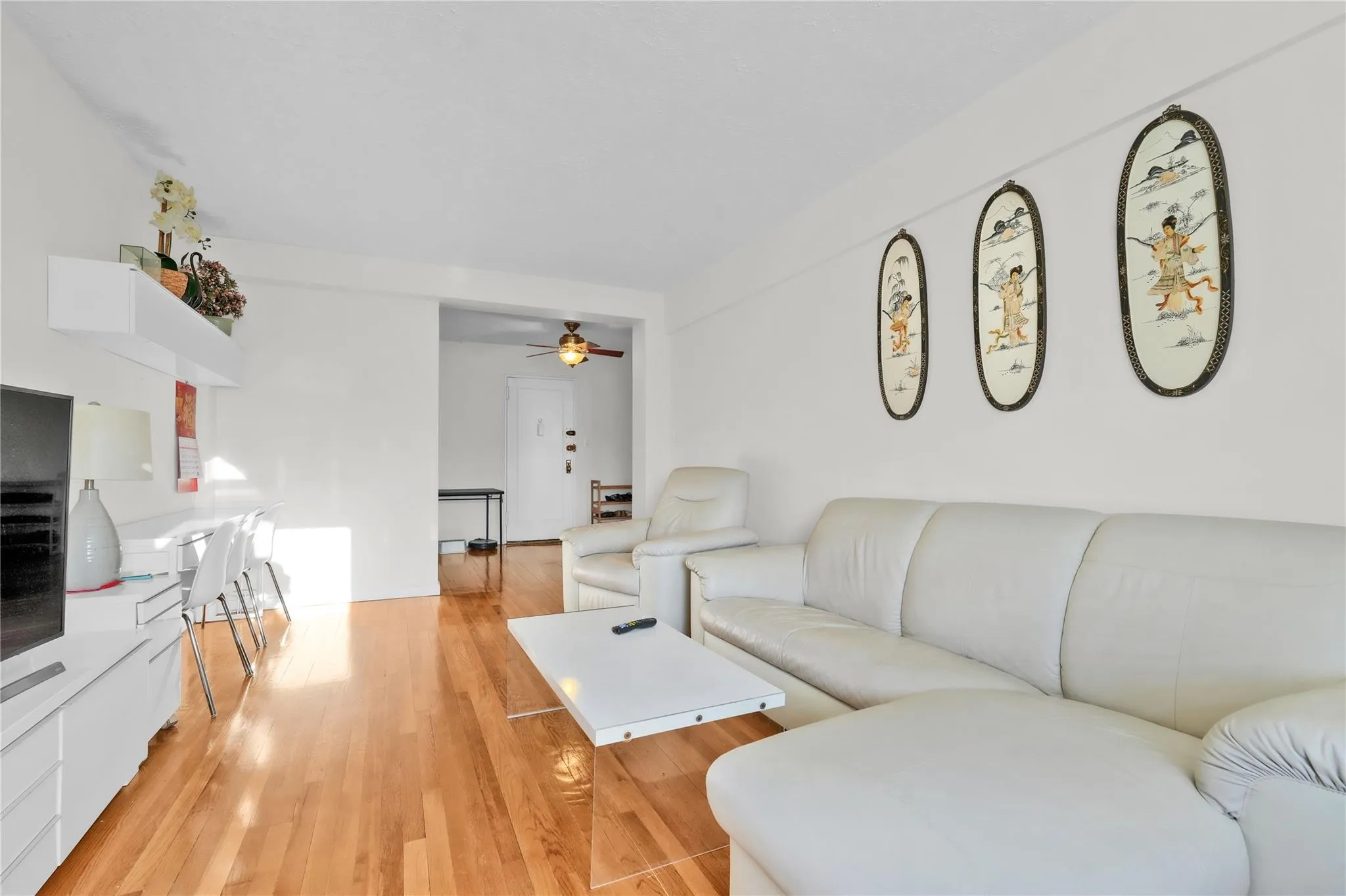 Living area with ceiling fan and light wood-style floors Living area with ceiling fan and light wood-style floors