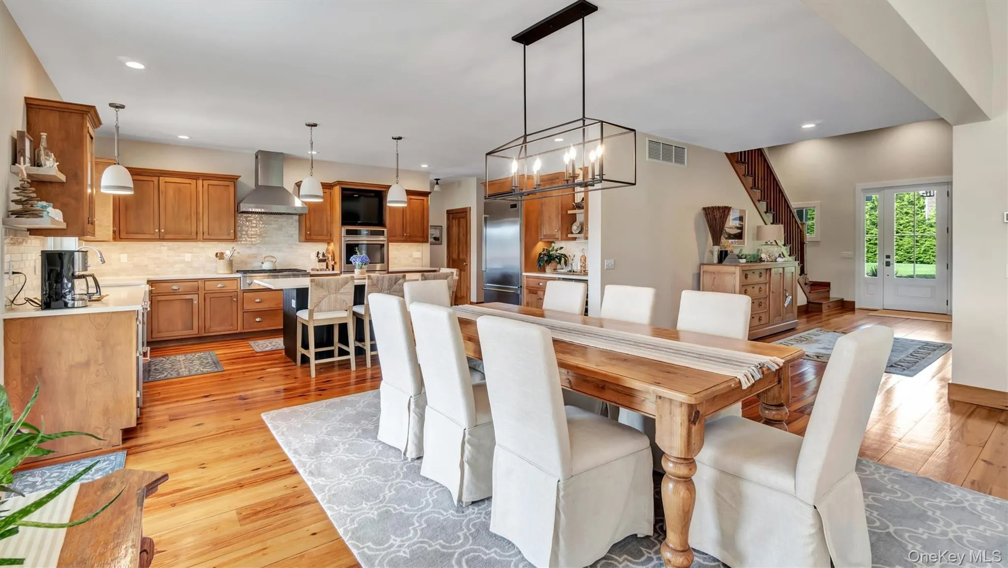 Dining area featuring light wood finished floors, a chandelier, and recessed lighting Dining area featuring light wood finished floors, a chandelier, and recessed lighting