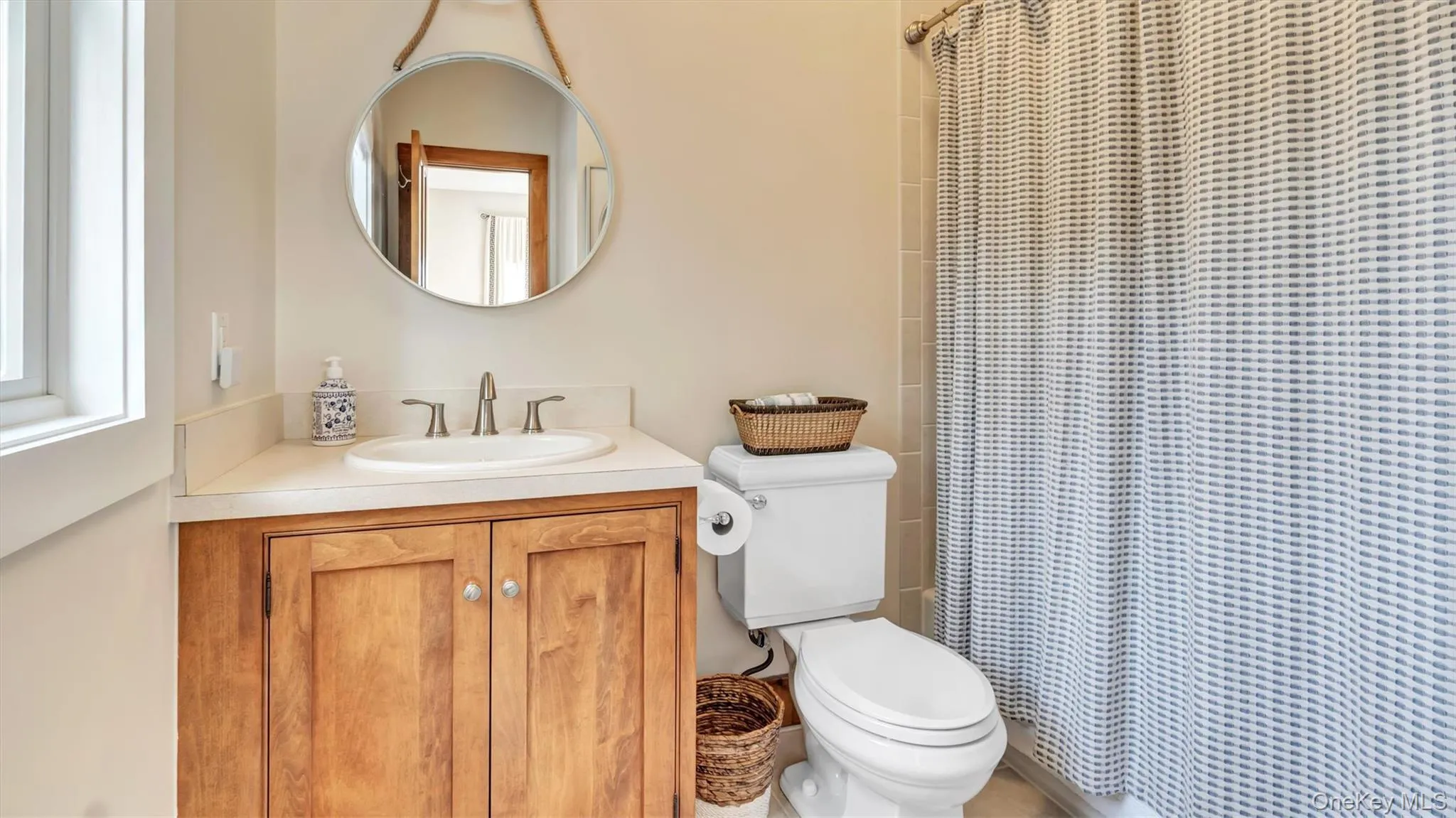 Bathroom featuring vanity and a shower with curtain Bathroom featuring vanity and a shower with curtain