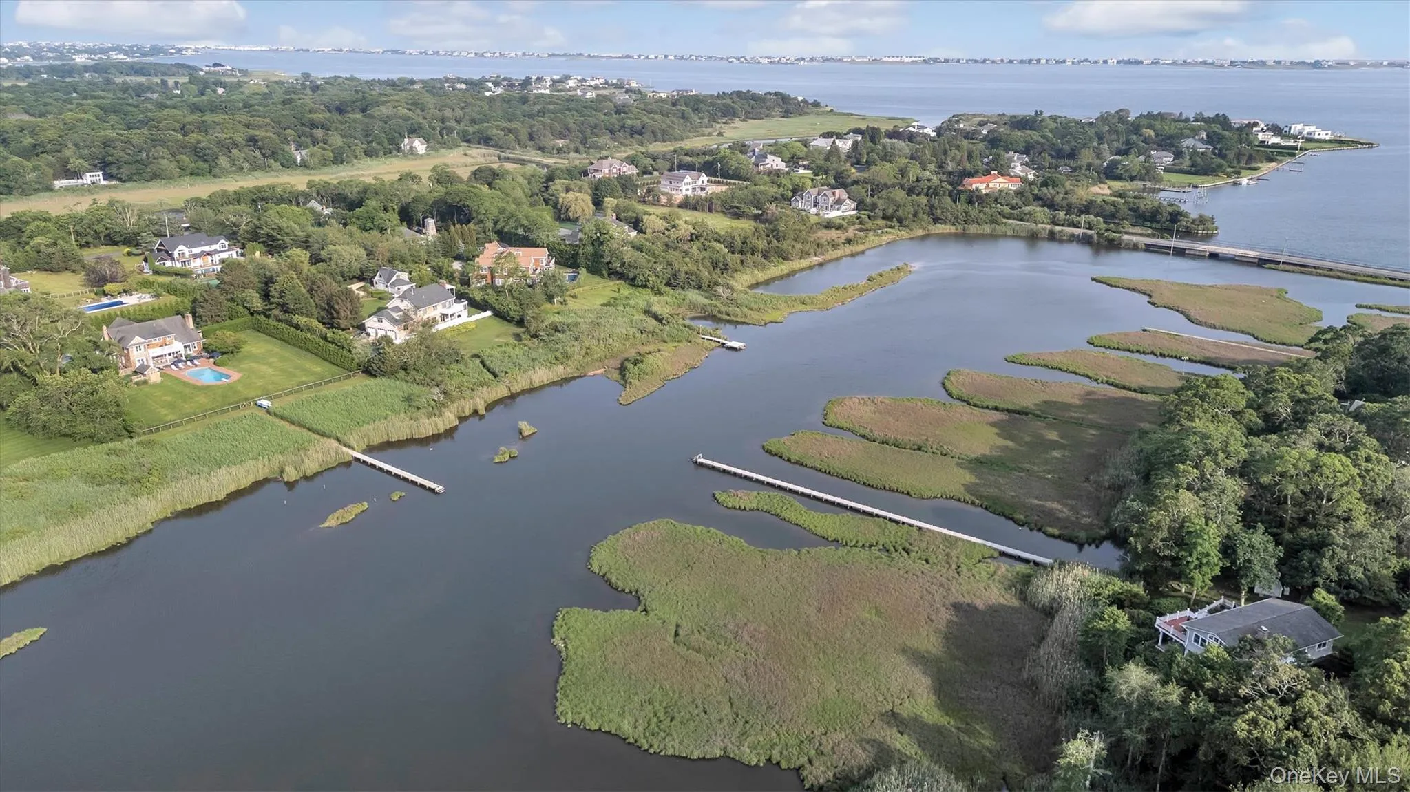 Aerial view of property and surrounding area with a nearby body of water Aerial view of property and surrounding area with a nearby body of water