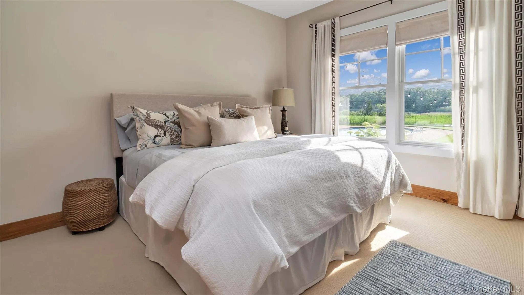 Bedroom featuring light colored carpet and baseboards Bedroom featuring light colored carpet and baseboards