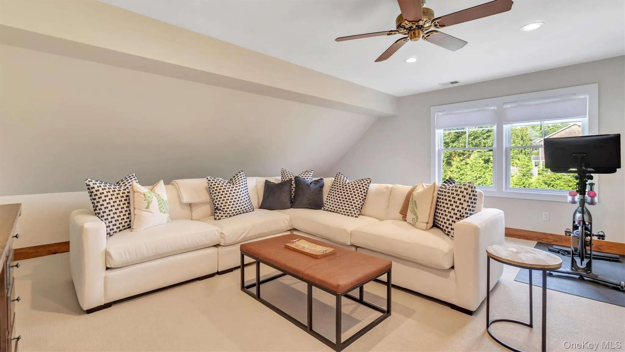 Living area featuring recessed lighting, ceiling fan, and vaulted ceiling Living area featuring recessed lighting, ceiling fan, and vaulted ceiling