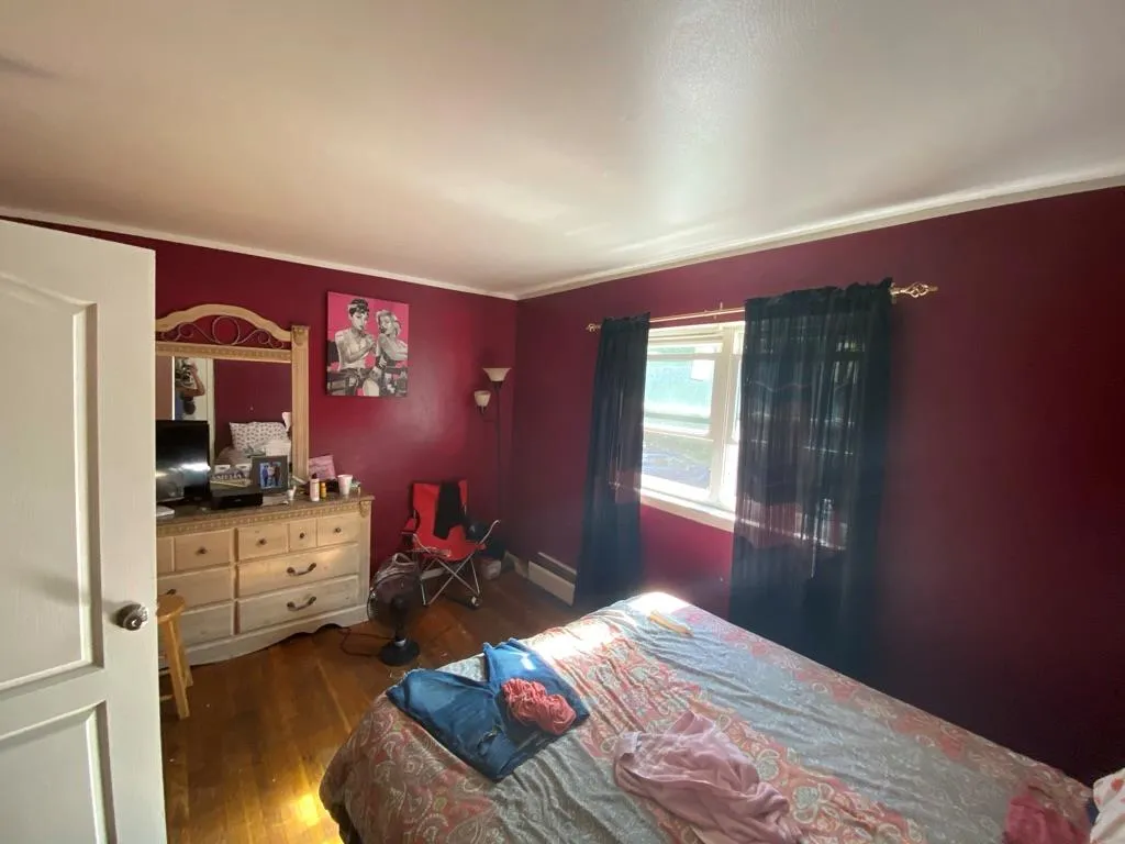 Bedroom featuring wood finished floors and ornamental molding Bedroom featuring wood finished floors and ornamental molding