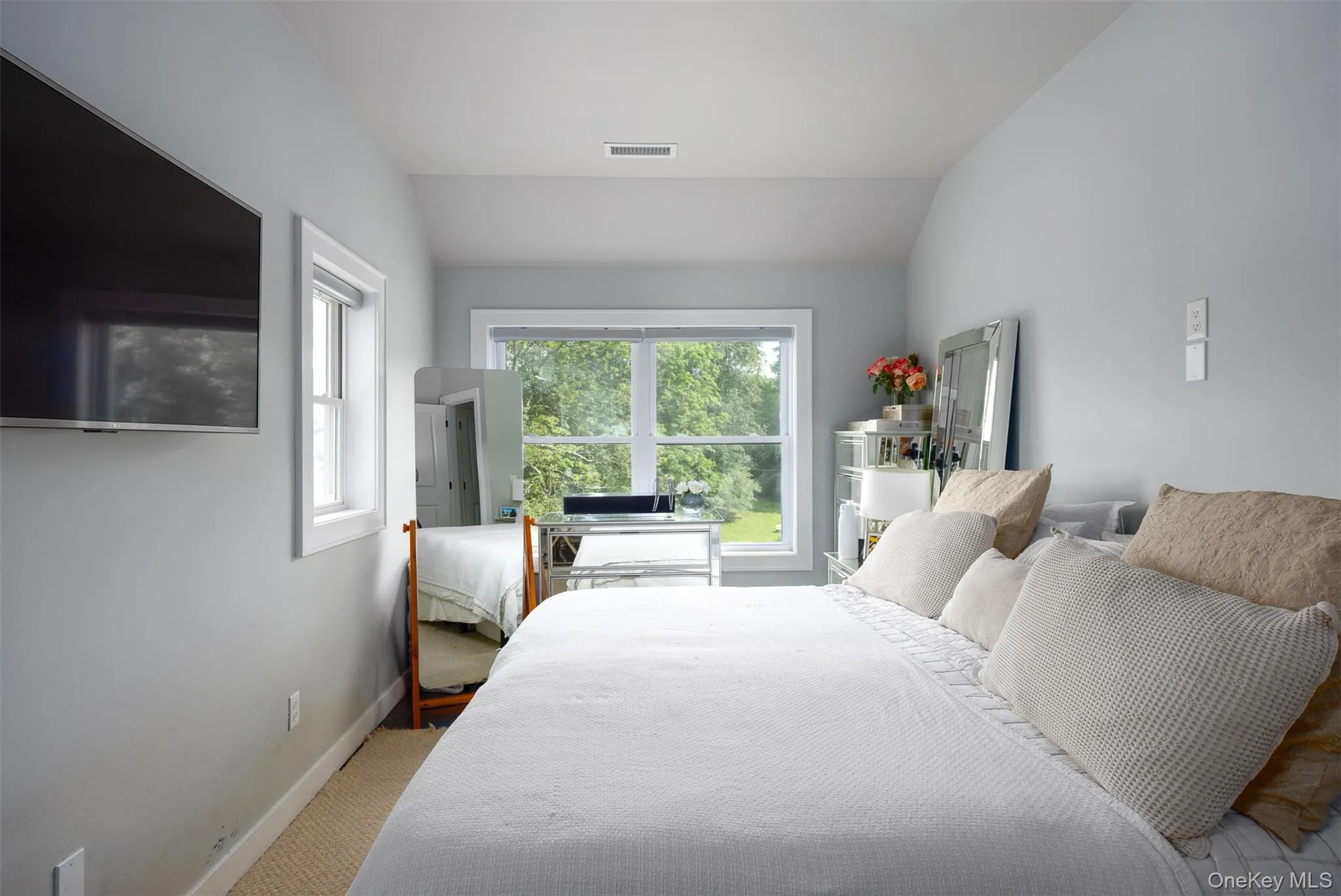 Bedroom featuring lofted ceiling and carpet flooring Bedroom featuring lofted ceiling and carpet flooring