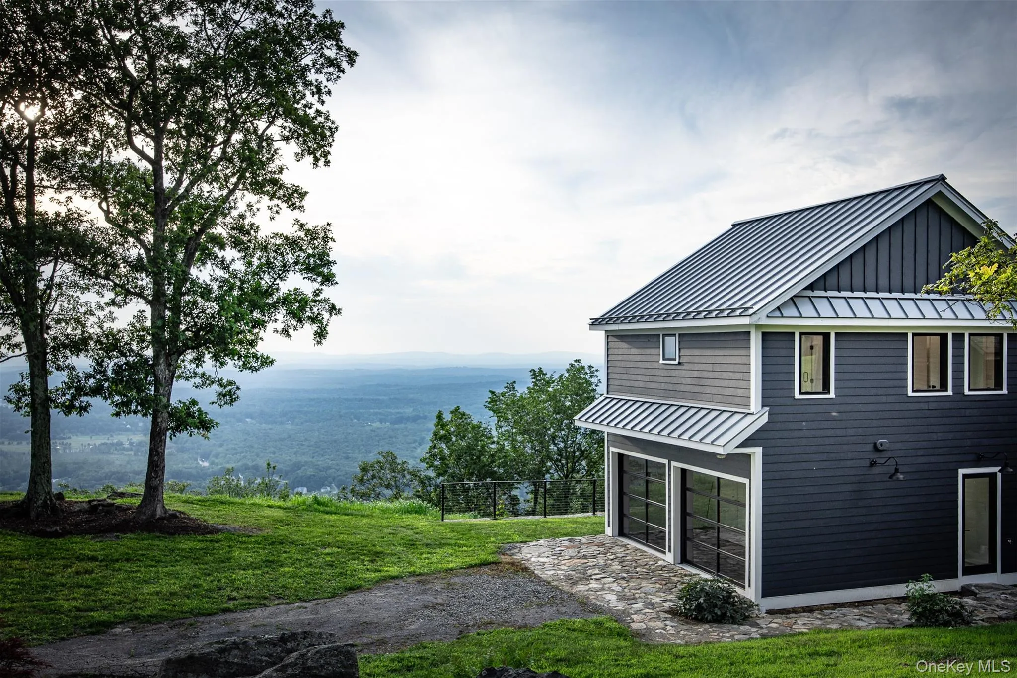 Rear view of property featuring a standing seam roof and a metal roof Rear view of property featuring a standing seam roof and a metal roof