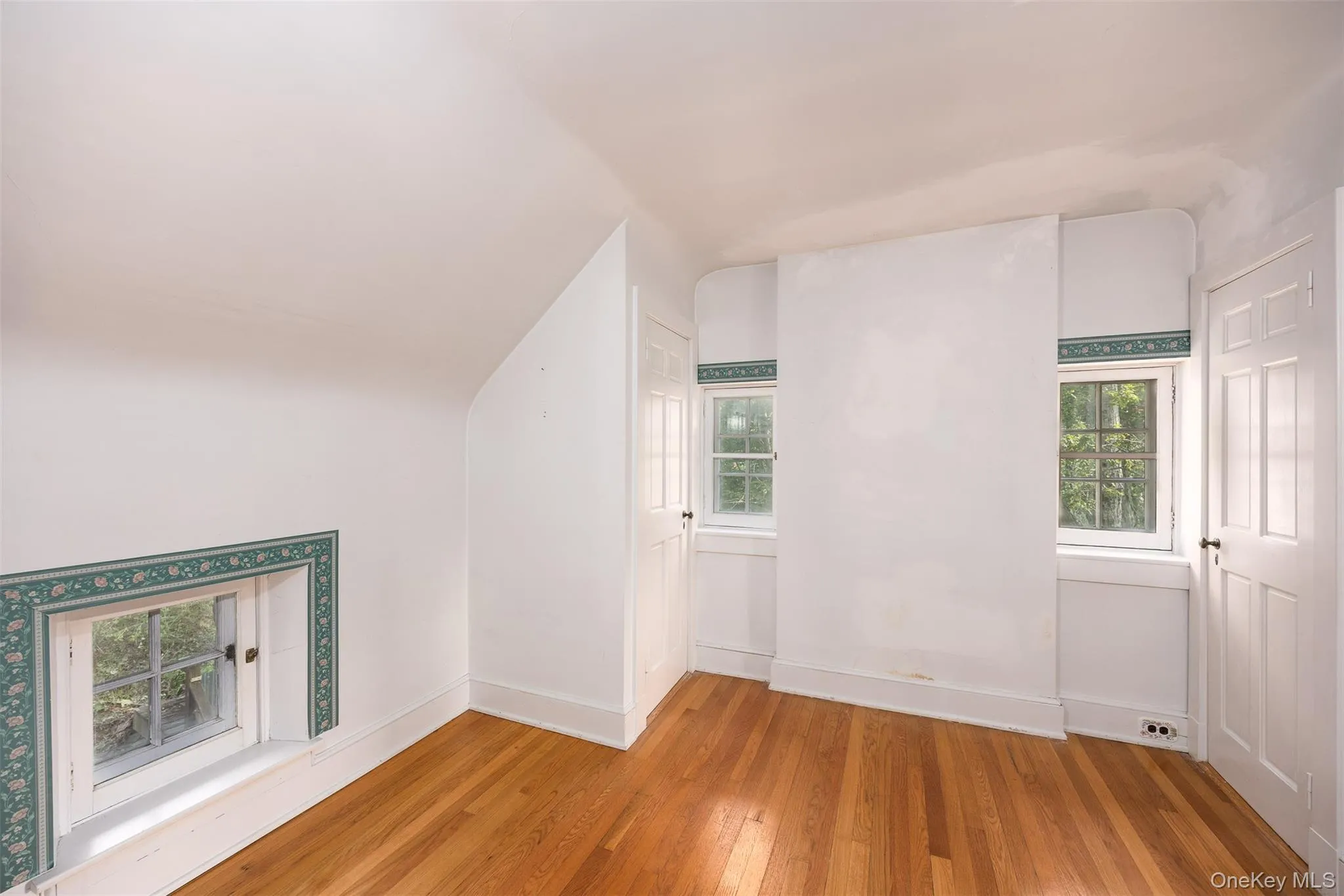 Additional living space with light wood-style floors and plenty of natural light Additional living space with light wood-style floors and plenty of natural light