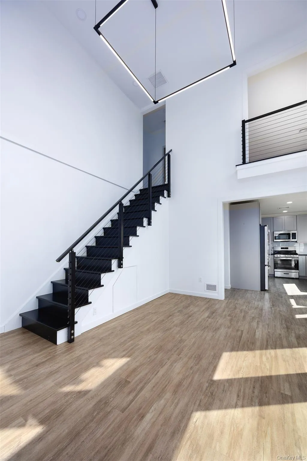 Staircase with a high ceiling and wood finished floors Staircase with a high ceiling and wood finished floors
