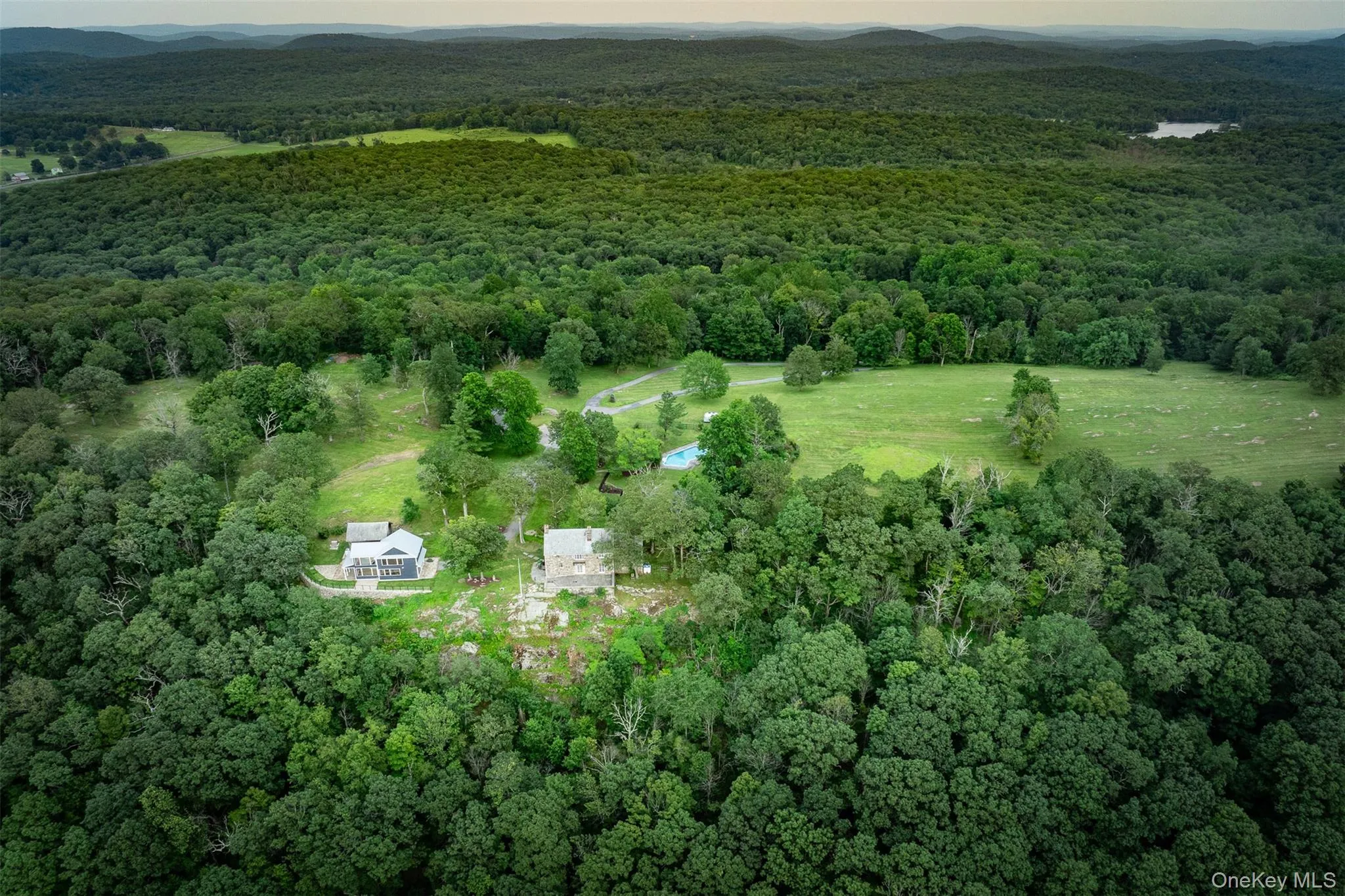 Aerial view of property's location with a heavily wooded area Aerial view of property's location with a heavily wooded area