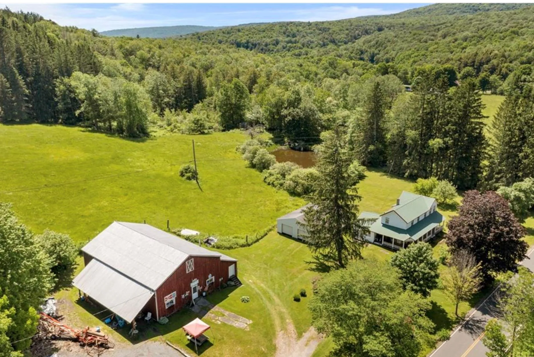View from above of property with a heavily wooded area View from above of property with a heavily wooded area