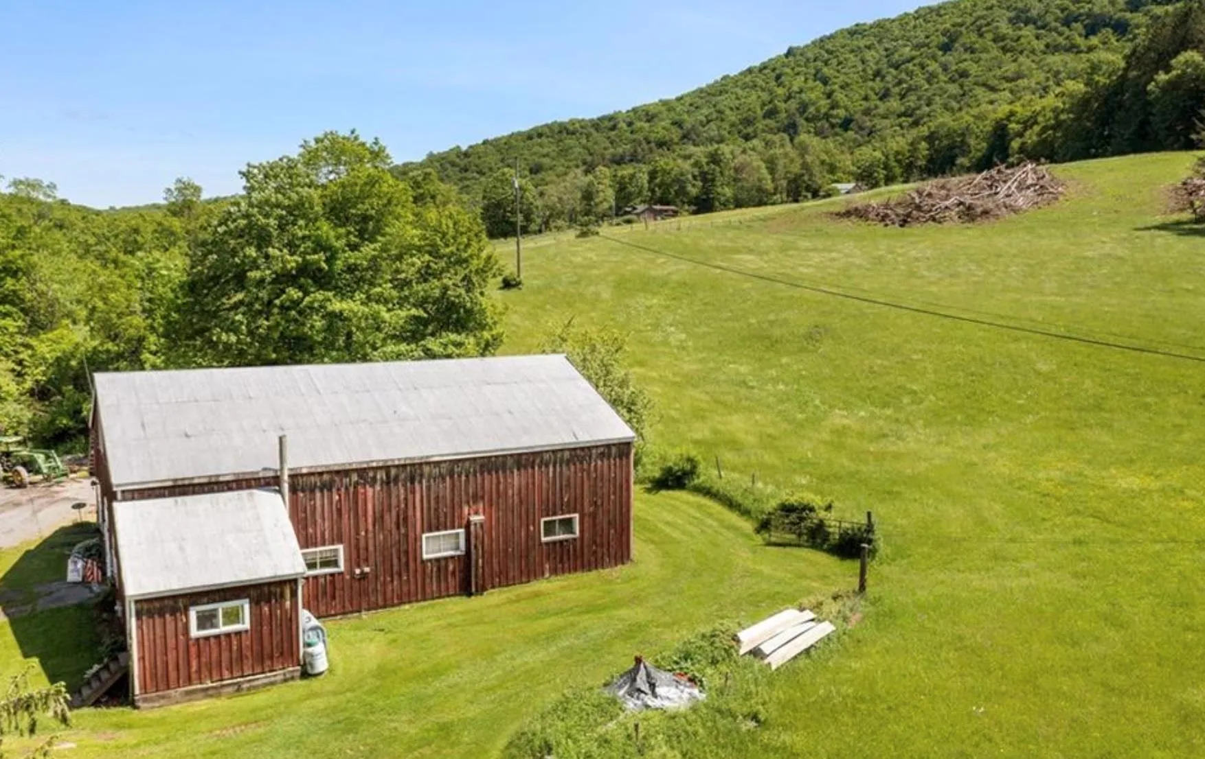 View from above of property with a heavily wooded area View from above of property with a heavily wooded area