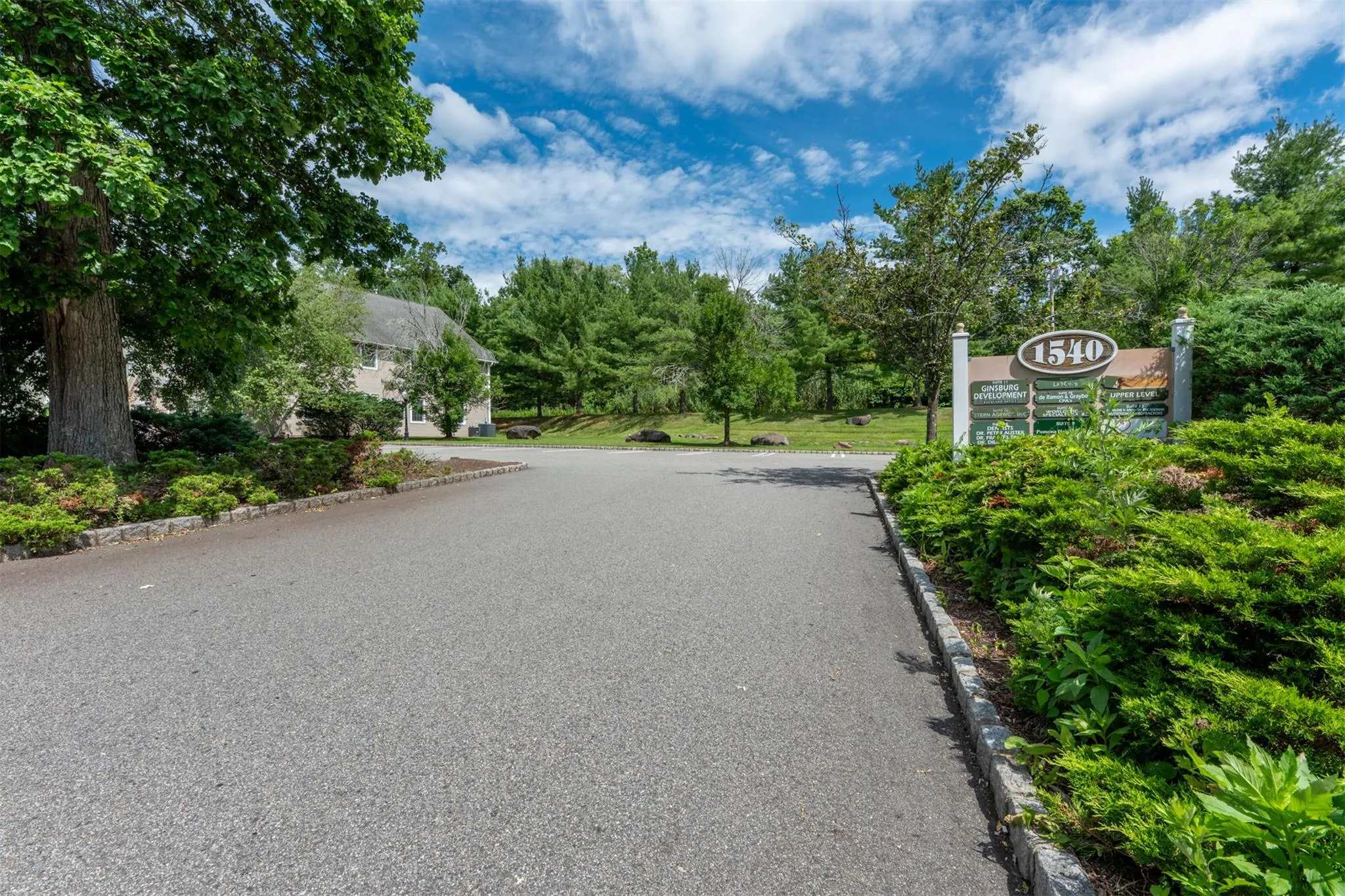 View of asphalt road with curbs View of asphalt road with curbs