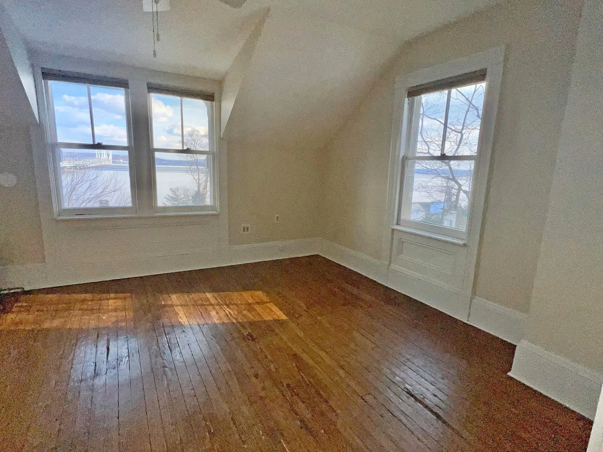 Additional living space featuring dark hardwood / wood-style flooring, a wealth of natural light, and lofted ceiling Additional living space featuring dark hardwood / wood-style flooring, a wealth of natural light, and lofted ceiling