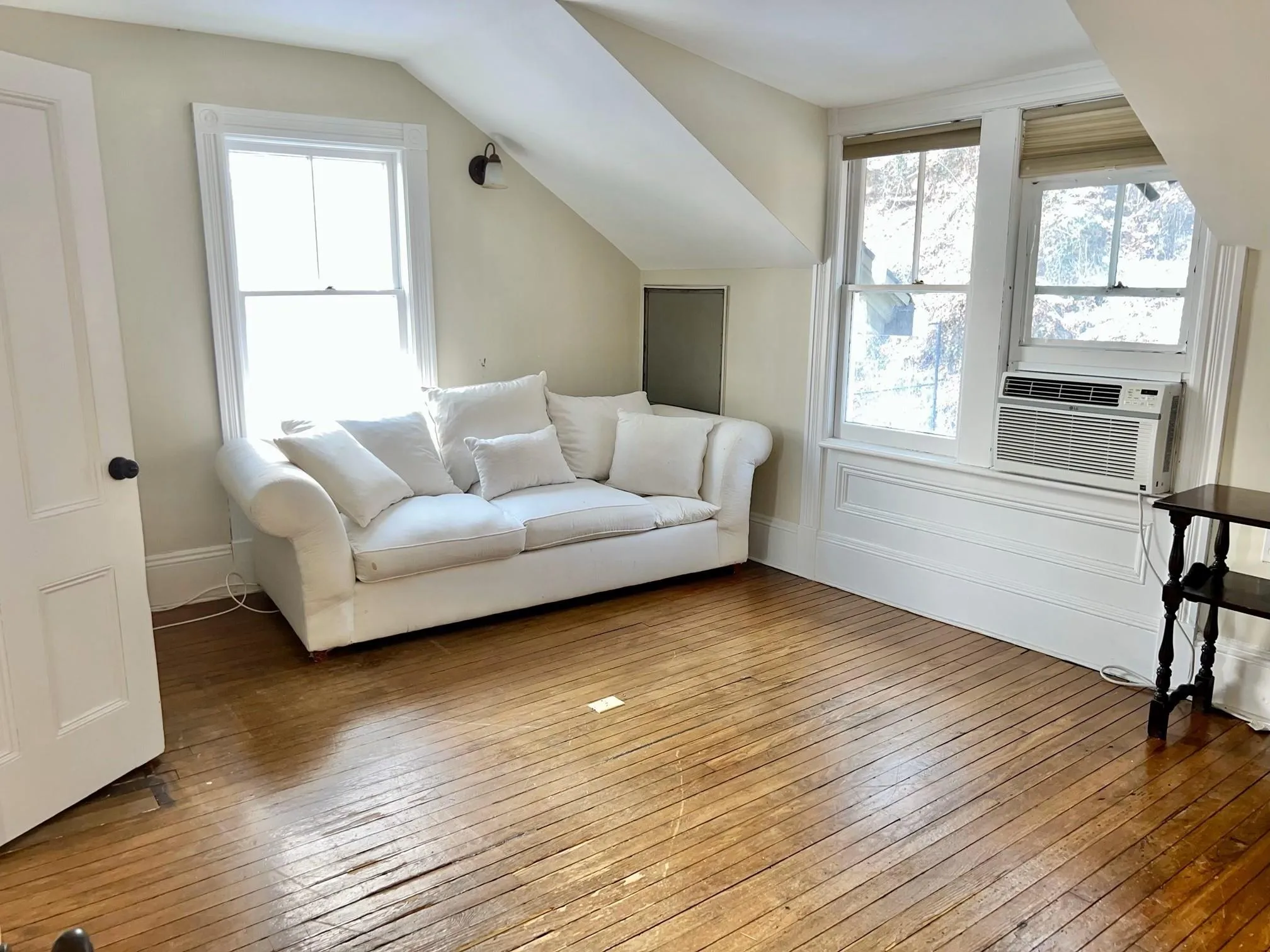 Living room with cooling unit, hardwood / wood-style flooring, and lofted ceiling Living room with cooling unit, hardwood / wood-style flooring, and lofted ceiling