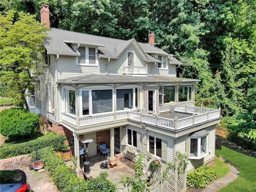 View of front of home featuring a balcony and a patio View of front of home featuring a balcony and a patio