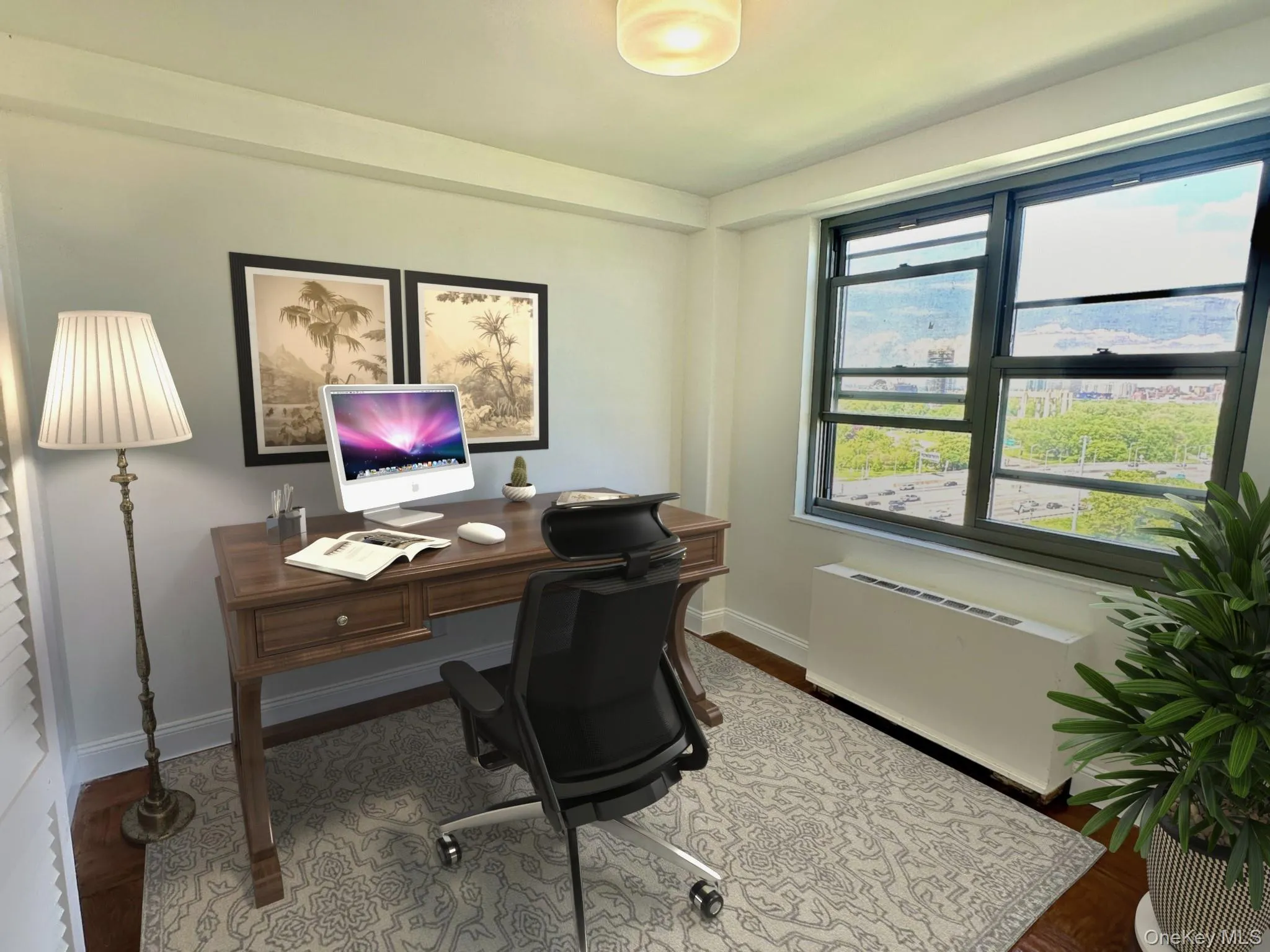 Office space featuring radiator heating unit and wood finished floors Office space featuring radiator heating unit and wood finished floors