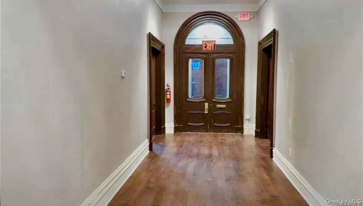 Doorway to outside with wood finished floors and baseboards Doorway to outside with wood finished floors and baseboards