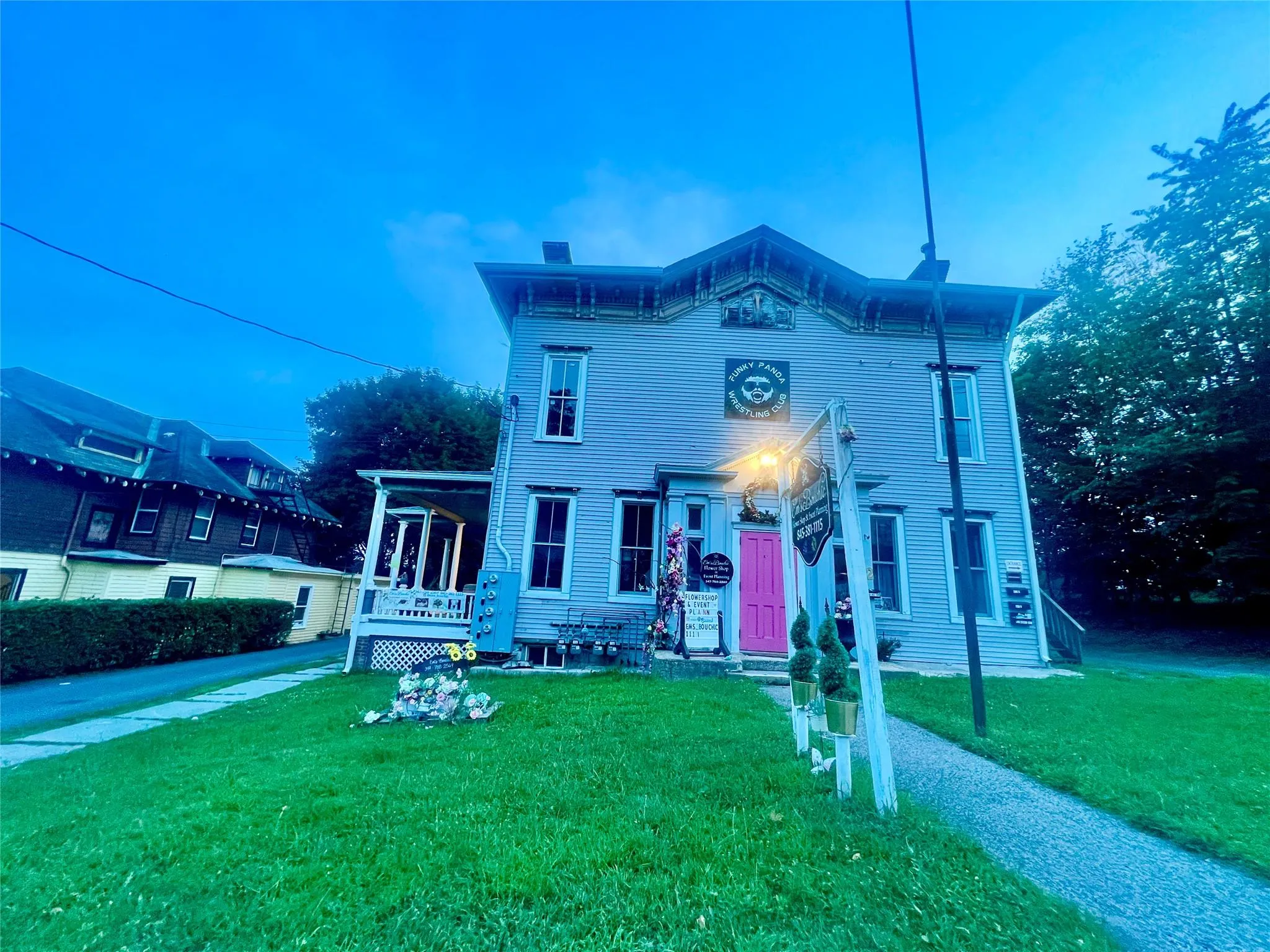 Italianate-style house featuring a chimney and a front yard Italianate-style house featuring a chimney and a front yard