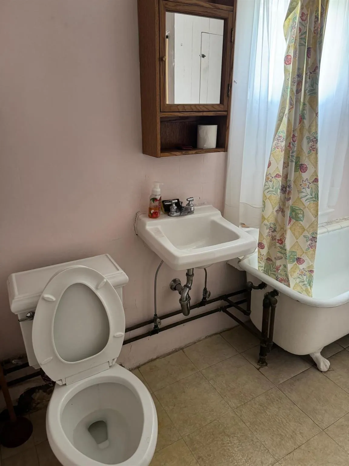 Bathroom featuring a bathtub and a shower with shower curtain Bathroom featuring a bathtub and a shower with shower curtain