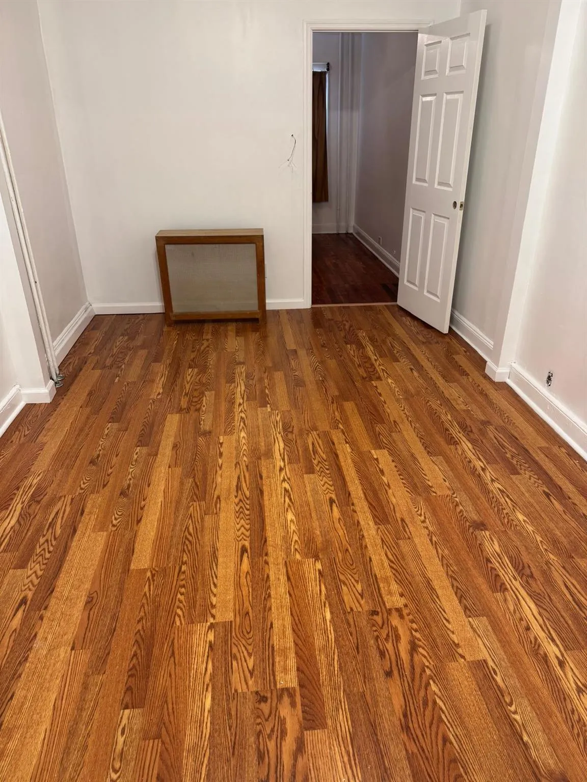 Spare room with wood finished floors and baseboards Spare room with wood finished floors and baseboards