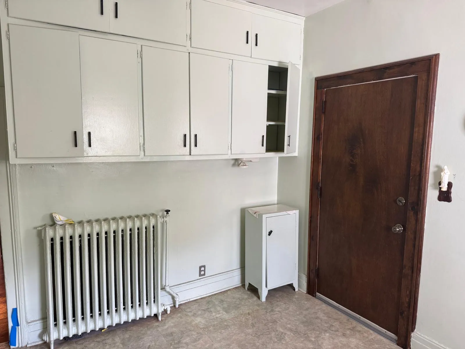 Washroom with radiator and baseboards Washroom with radiator and baseboards