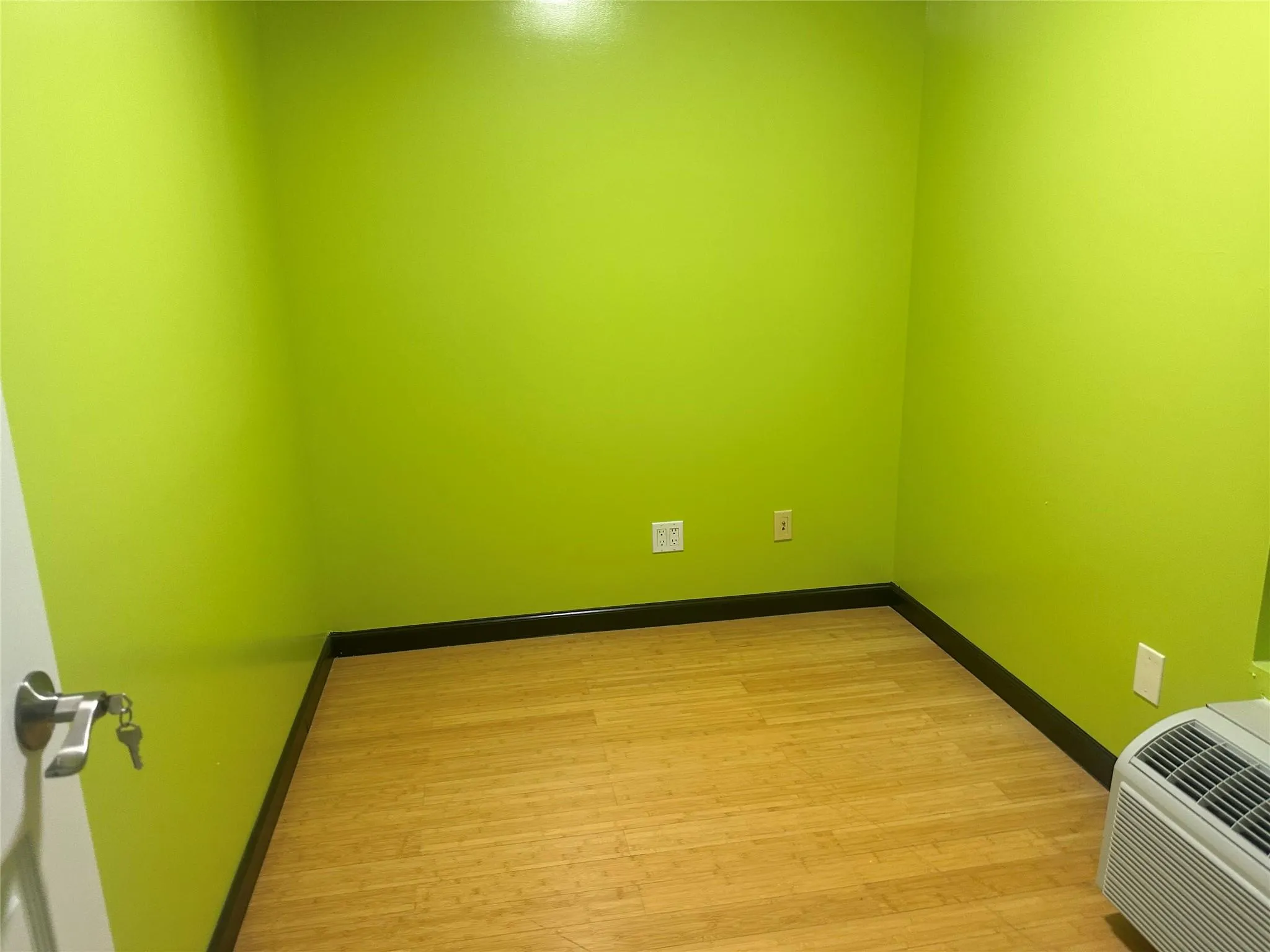 Unfurnished room with light wood-type flooring and a wall unit AC Unfurnished room with light wood-type flooring and a wall unit AC