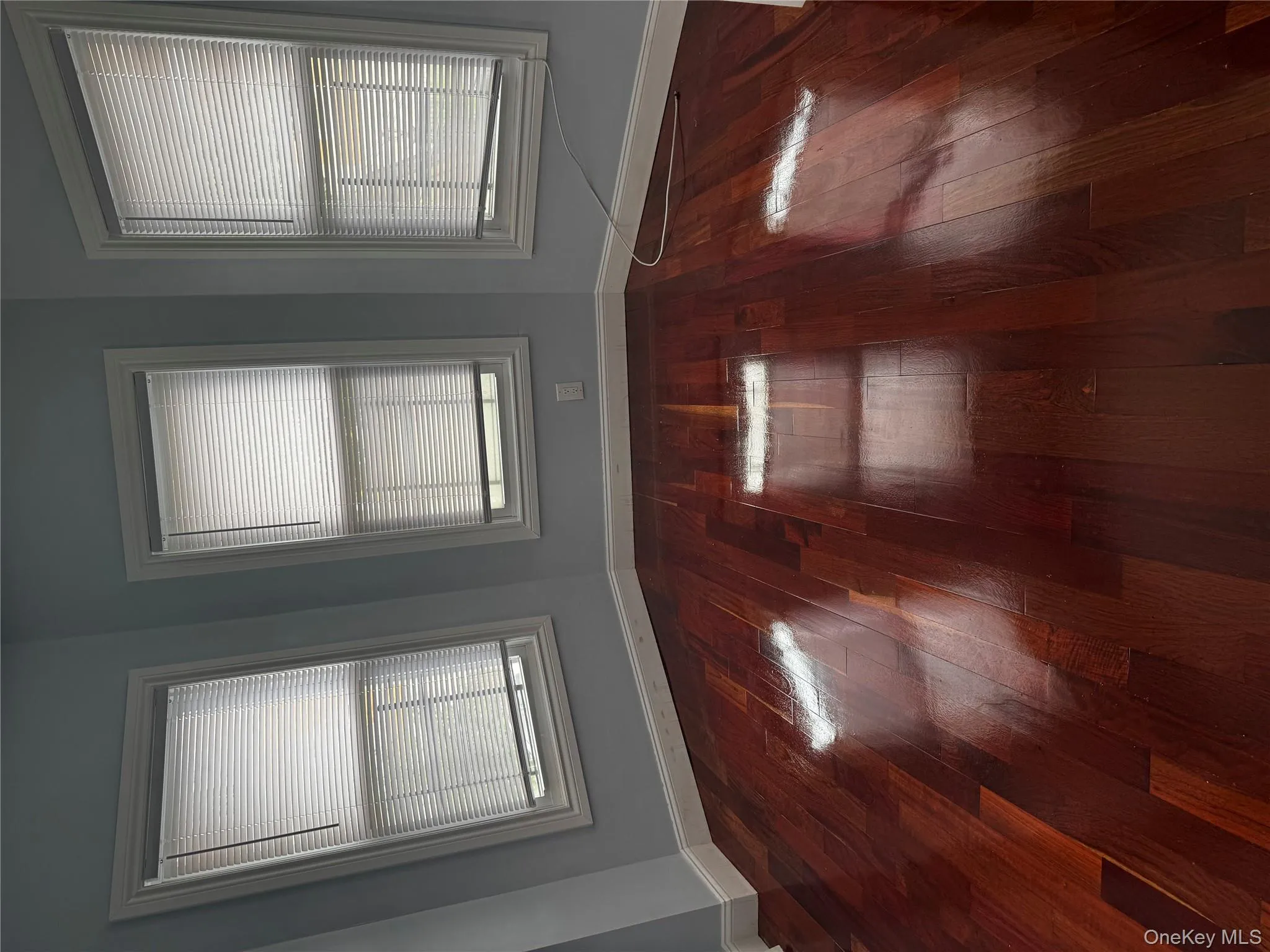 Unfurnished room featuring dark wood-style flooring Unfurnished room featuring dark wood-style flooring