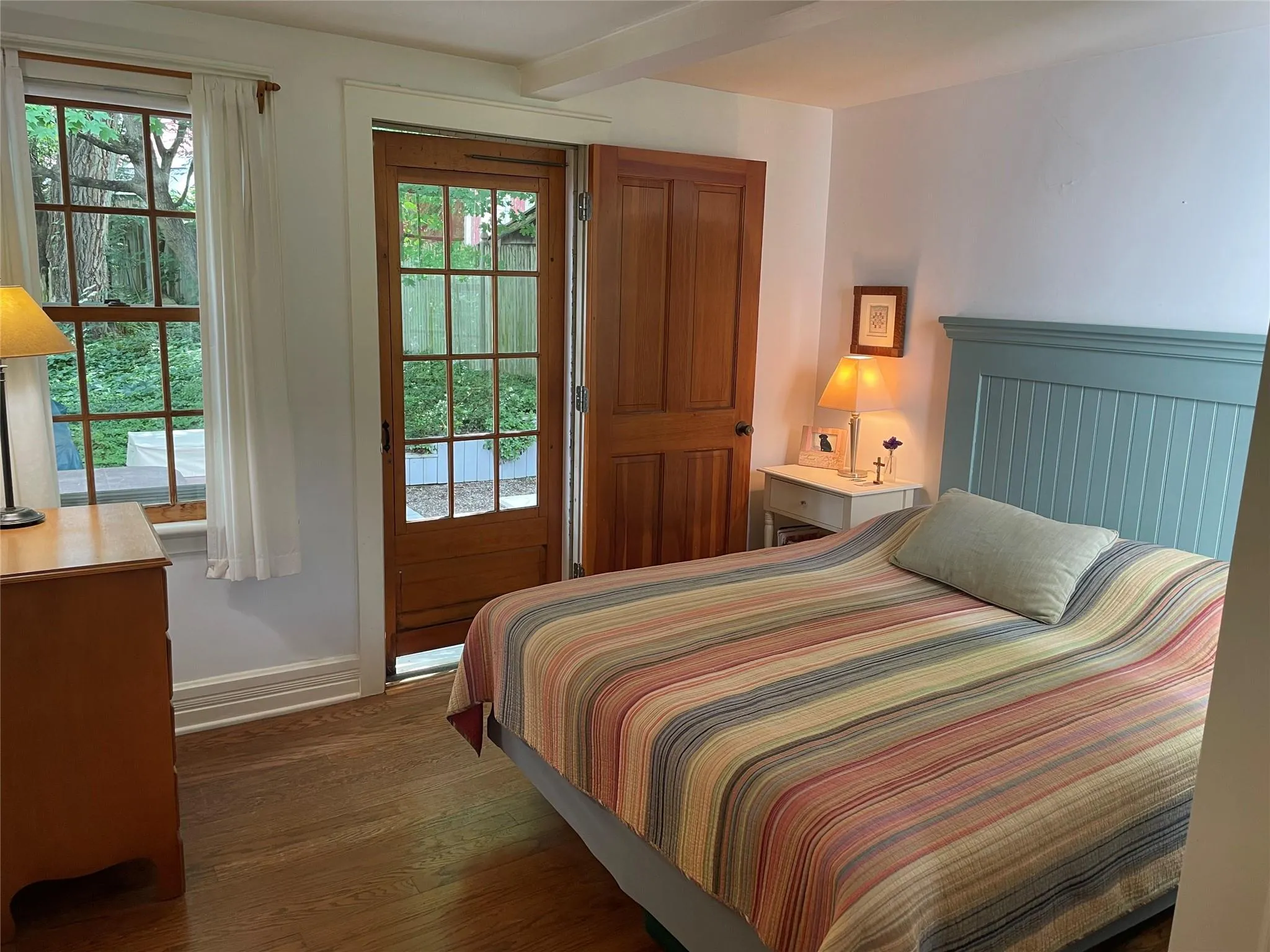 Bedroom featuring dark wood-style floors and access to outside Bedroom featuring dark wood-style floors and access to outside