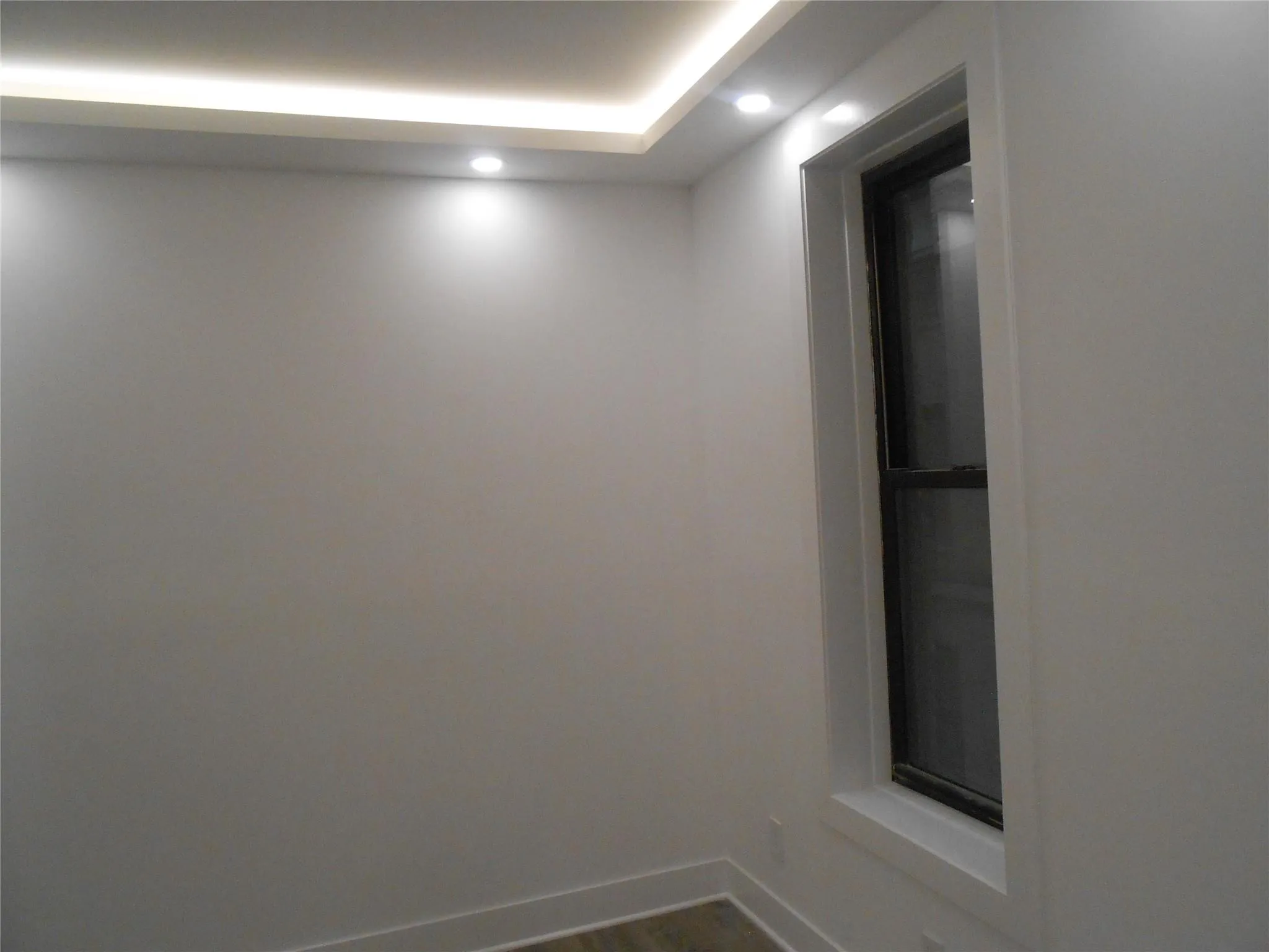 Unfurnished room with recessed lighting and dark wood finished floors Unfurnished room with recessed lighting and dark wood finished floors